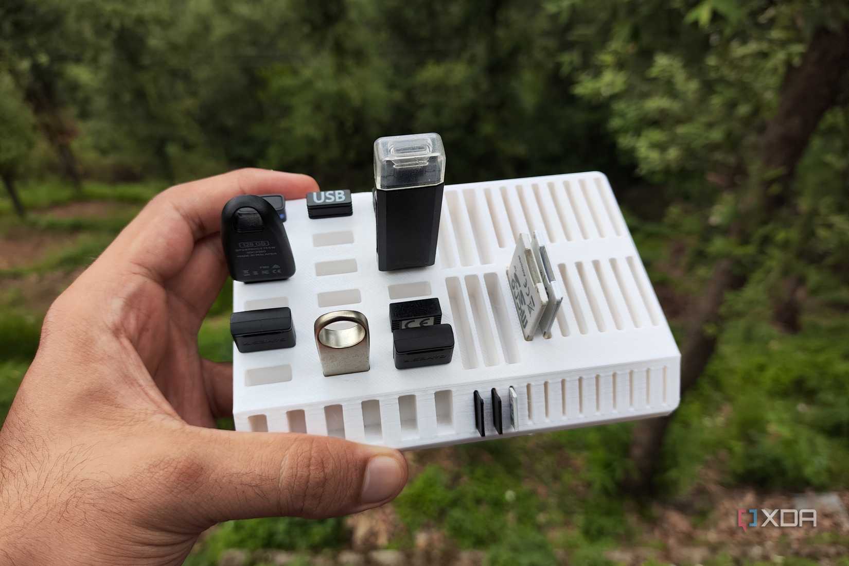 A person holding a 3D-printed USB tray