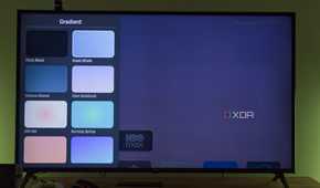A TV displaying Arc launcher customization options for the wallpaper gradient