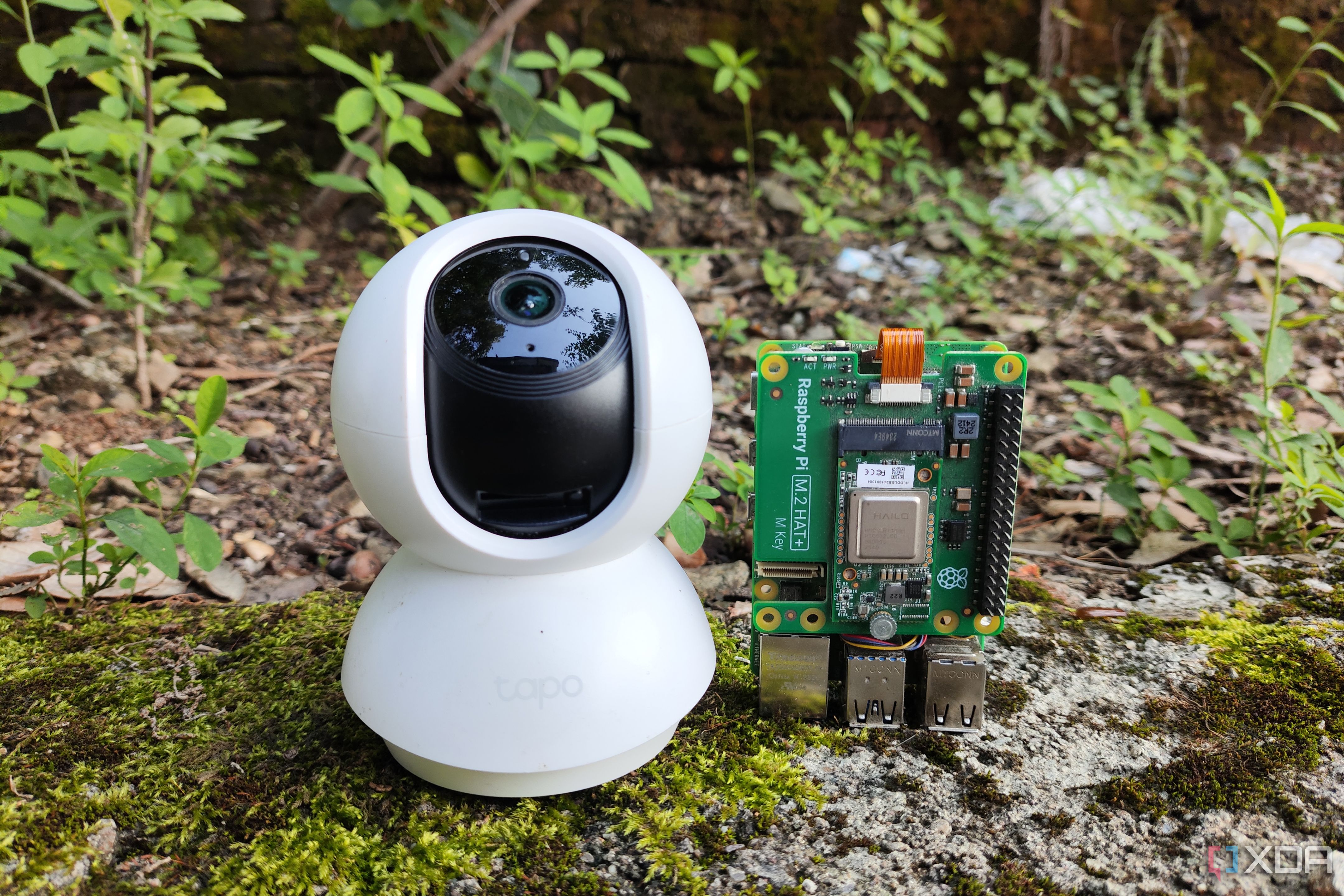 A security camera placed next to a Raspberry Pi SBC