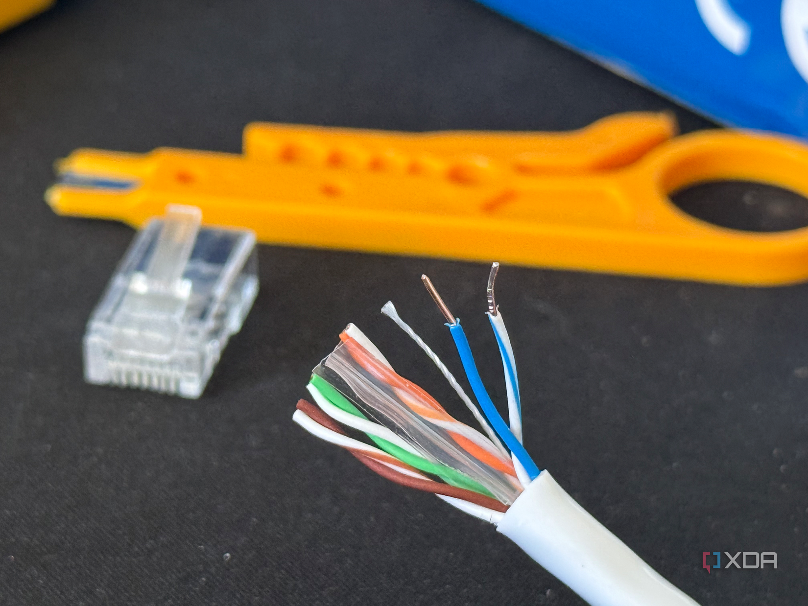 A photograph of a stripped Cat6 Ethernet cable showing CCA conductors