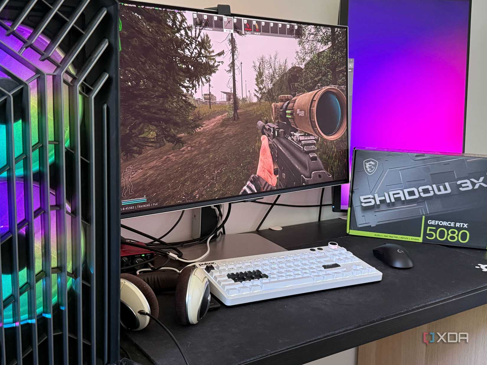 A photo of a PC running EFT, with an RTX 5080 box pictured