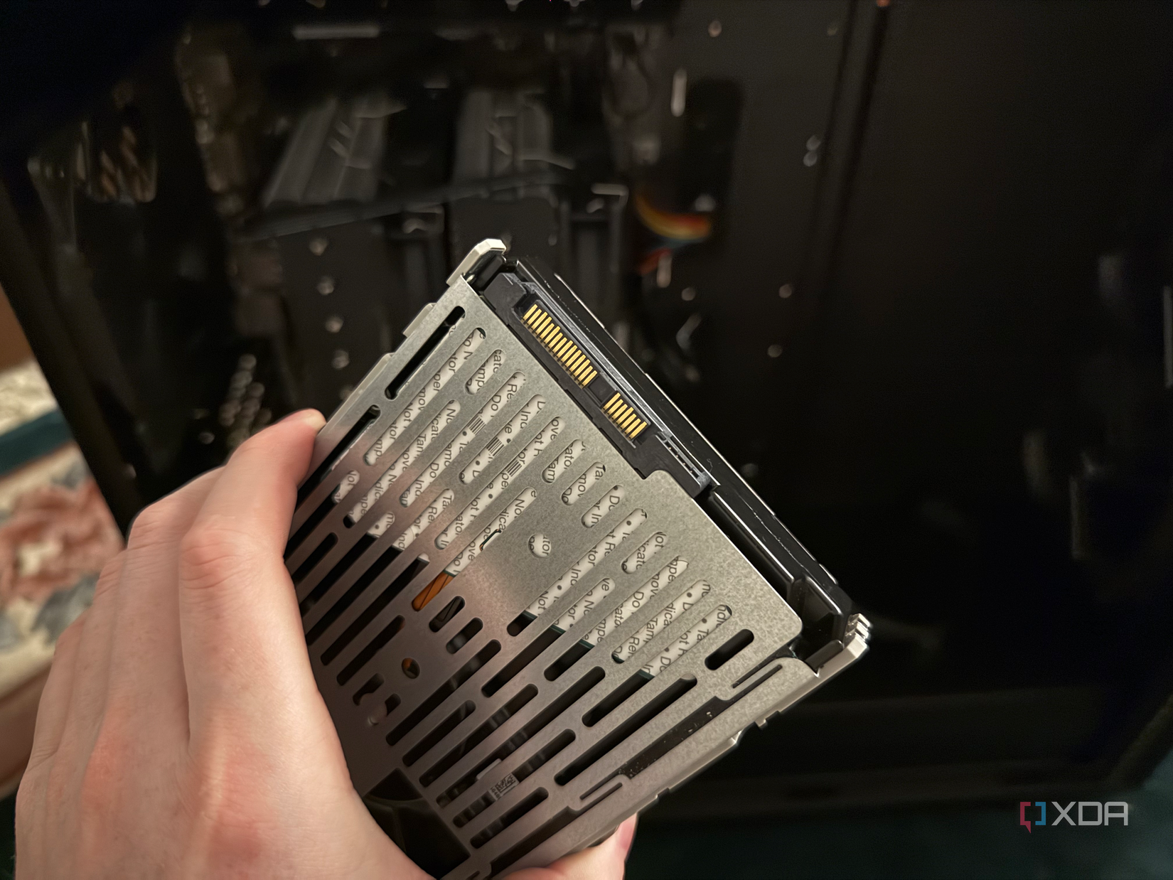 A photo of someone holding a SAS drive, showing the connection