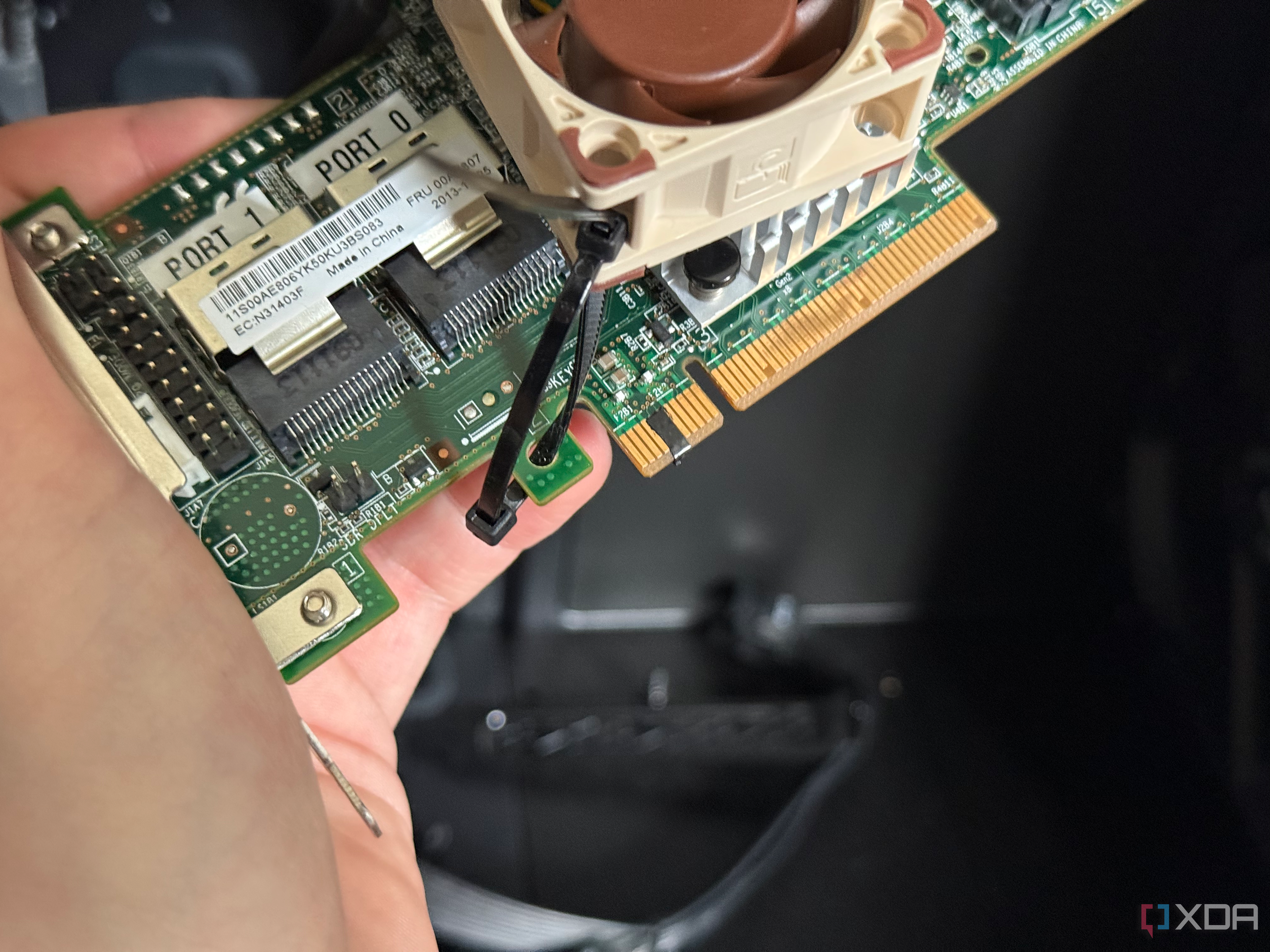 A photo of an HBA card with some electrical tape across the pins
