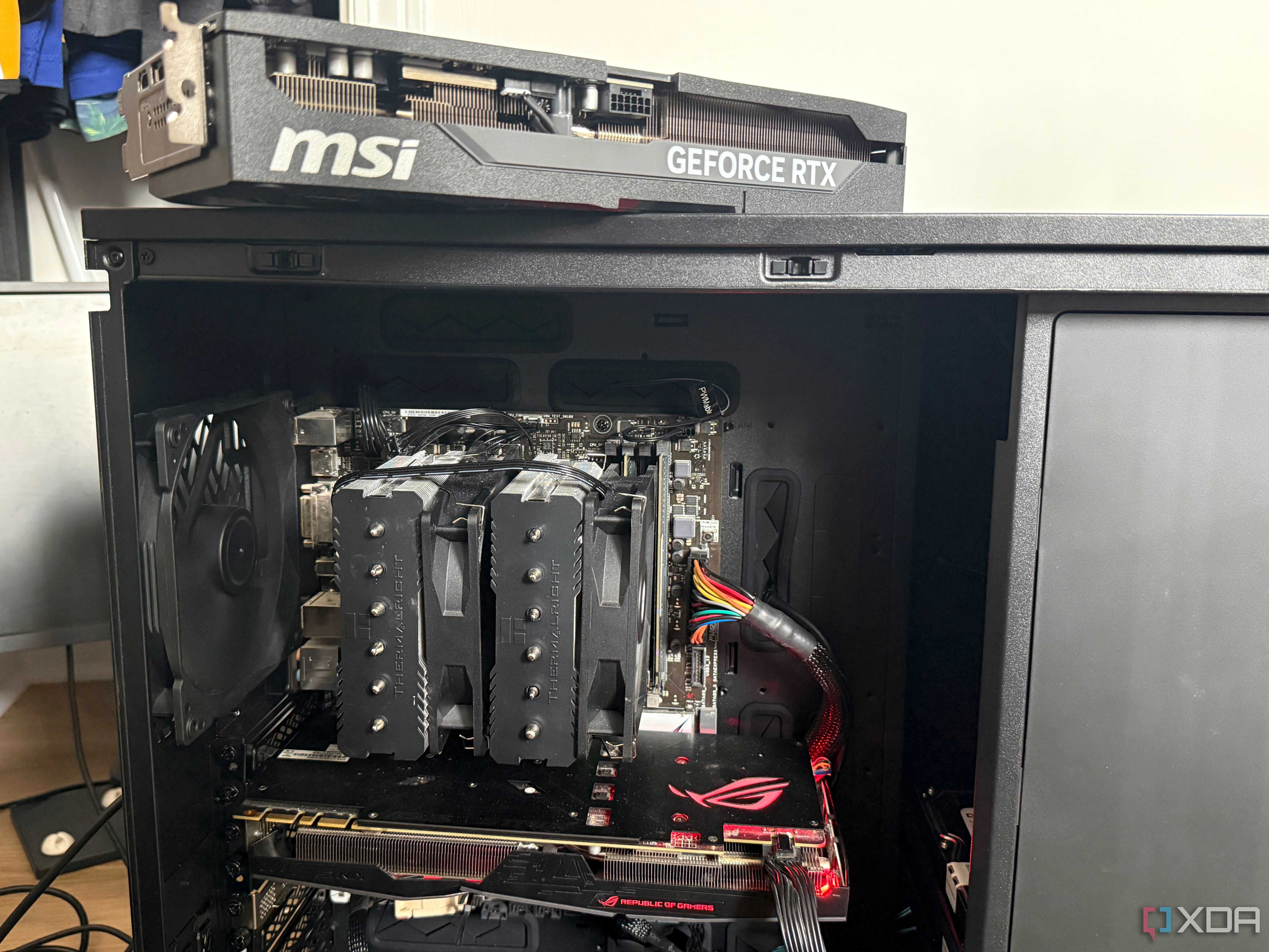 A photo of a home lab PC build with a GPU sitting on top of the chassis