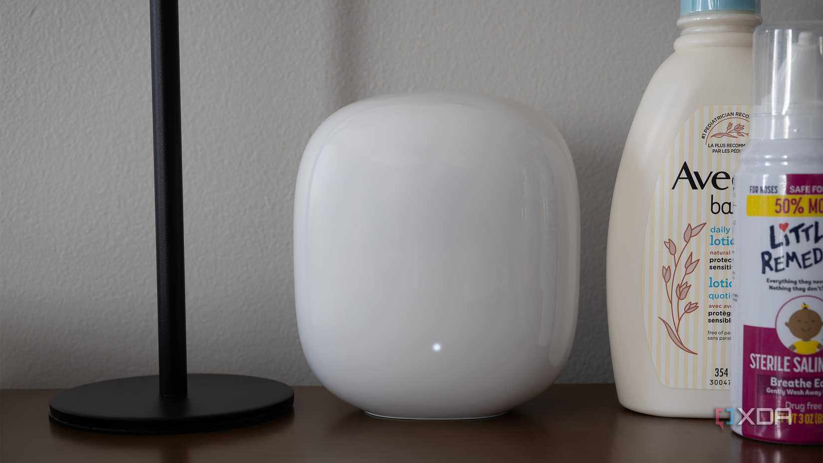 The Nest Wifi Pro sits on a table 