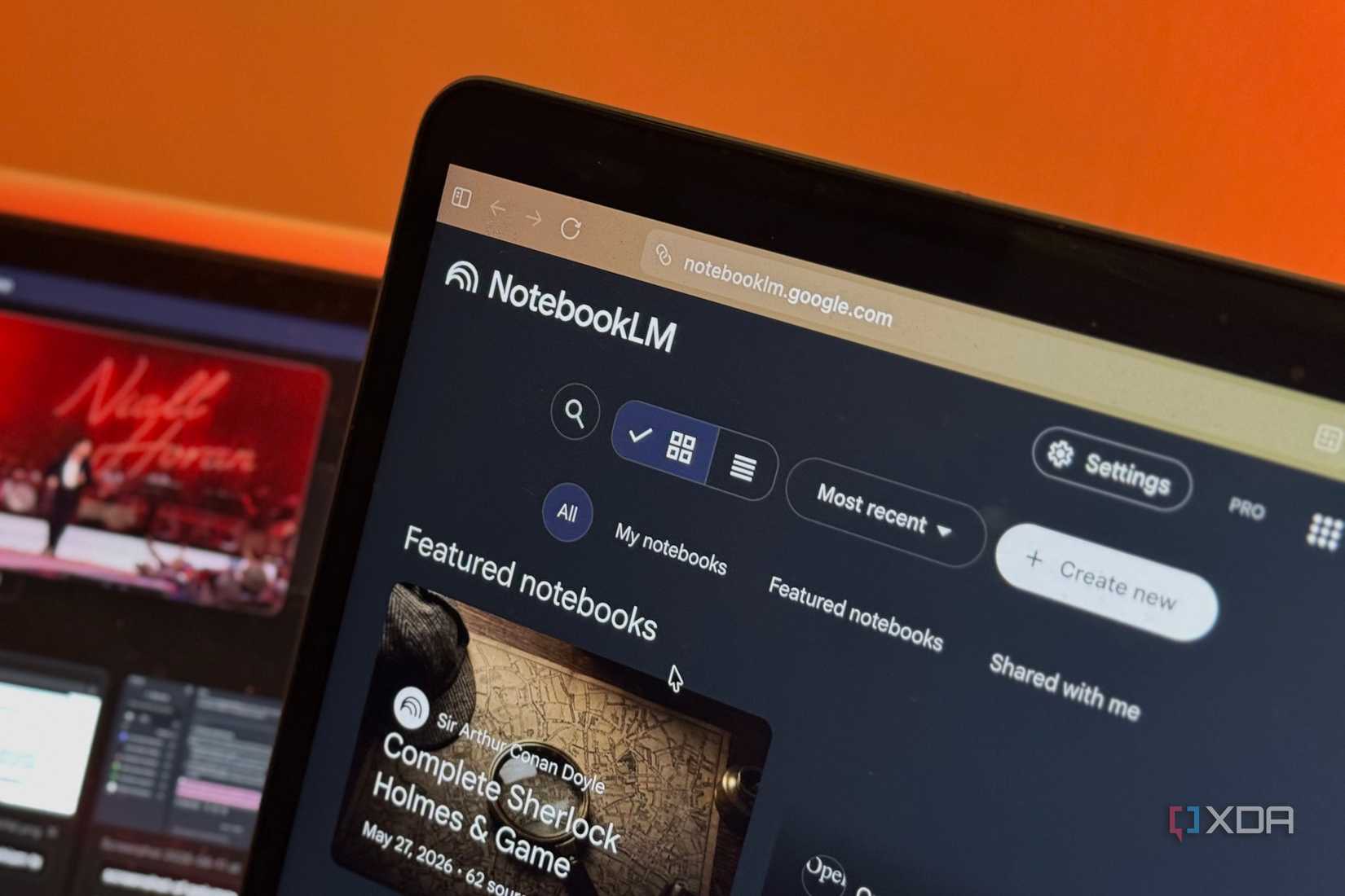 notebooklm interface displayed on laptop screen with orange background