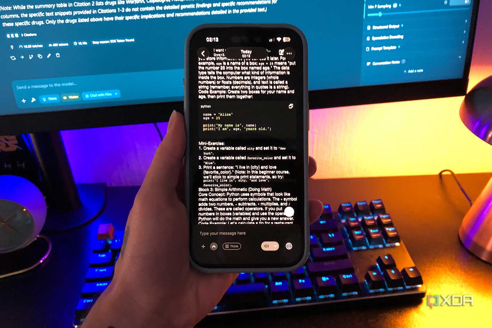 qwen 3.5 on iphone, desktop monitor and keyboard in background