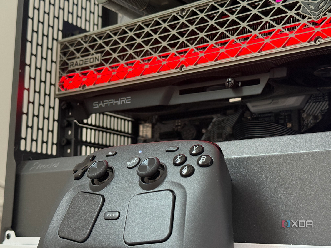A photo of a steam controller sitting in front of a PC build