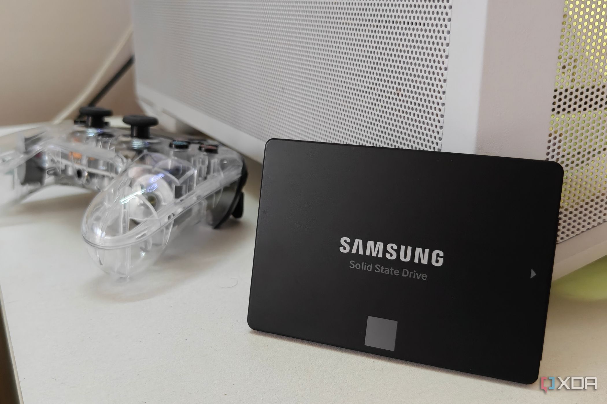 Samsung SATA SSD propped up against a white PC case.
