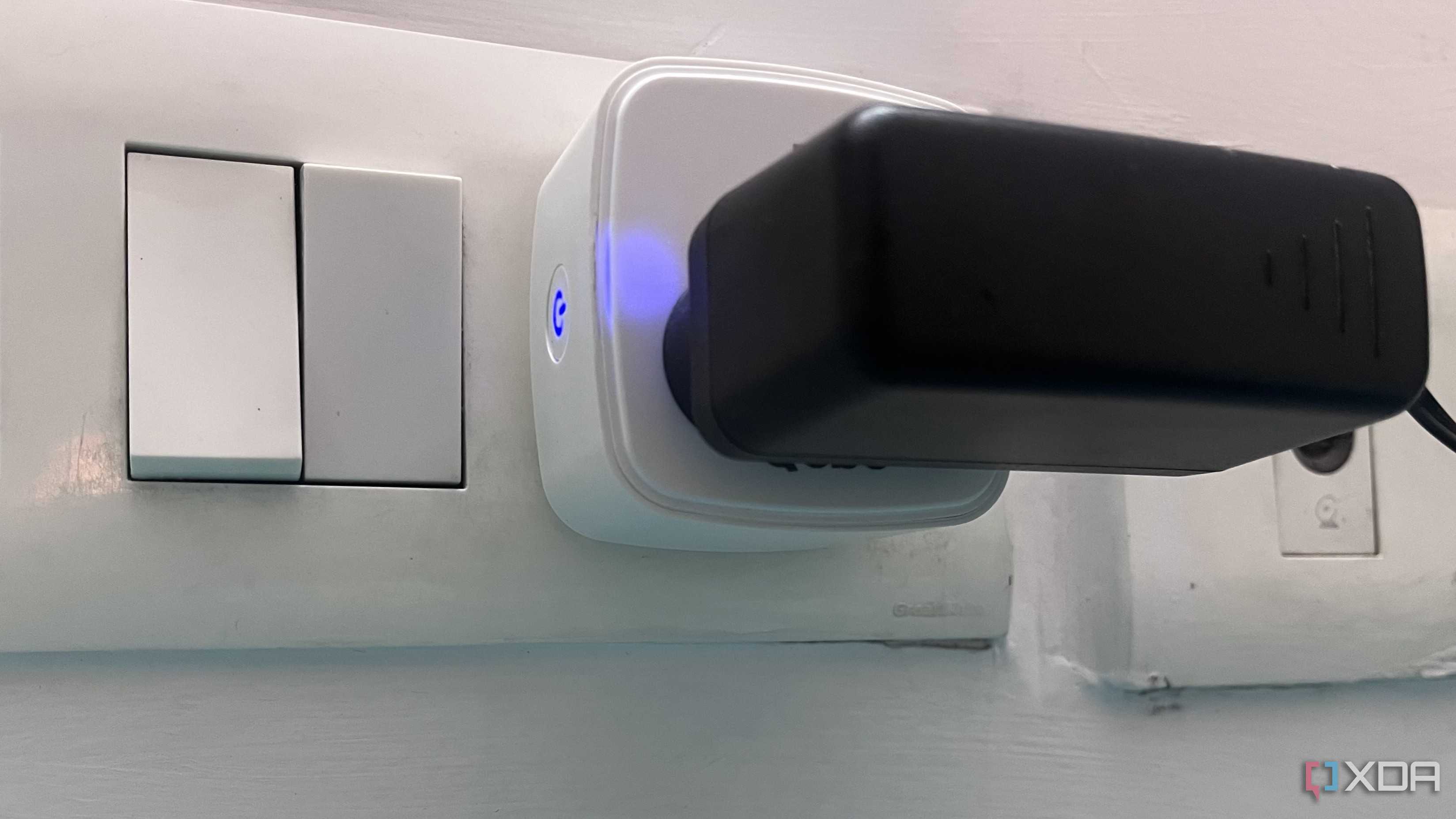 smart plug showing blue light with an adapter connected to it