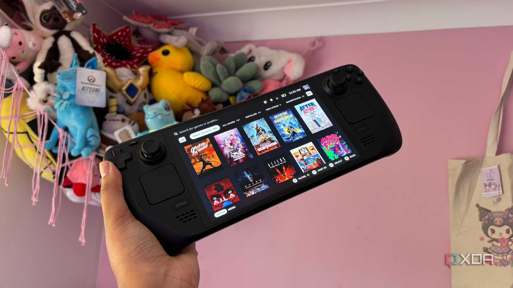 Steam Deck game menu with plush items in the background