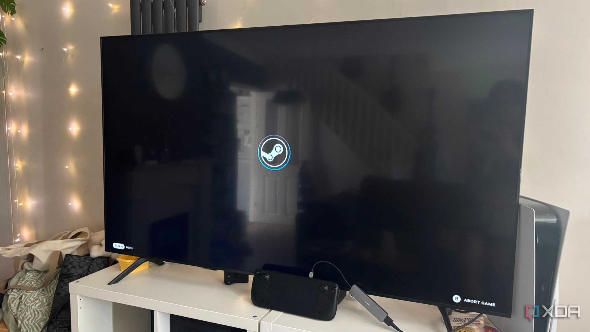 Steam Deck docked to TV steam logo on screen