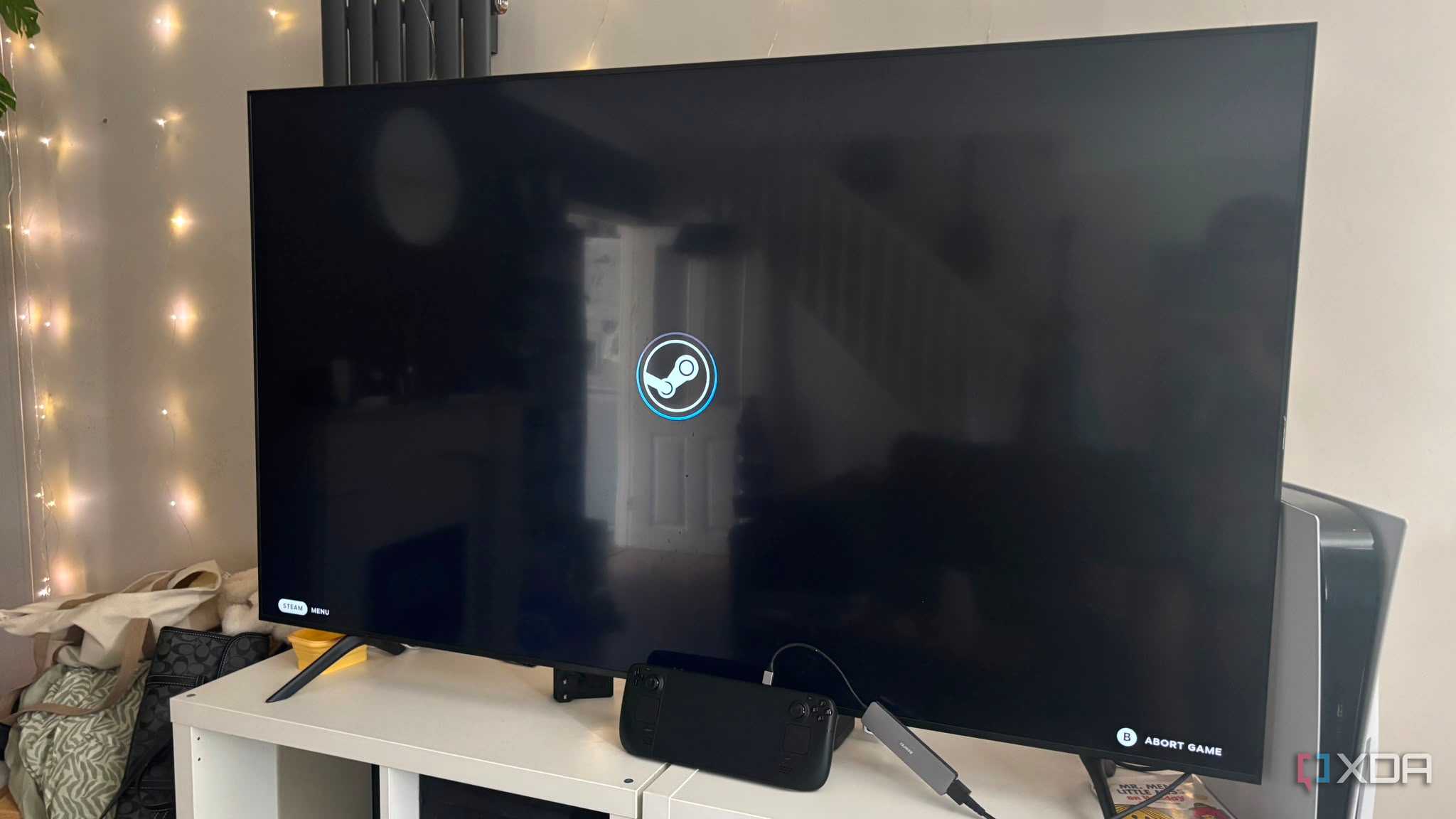 Steam Deck docked to TV steam logo on screen