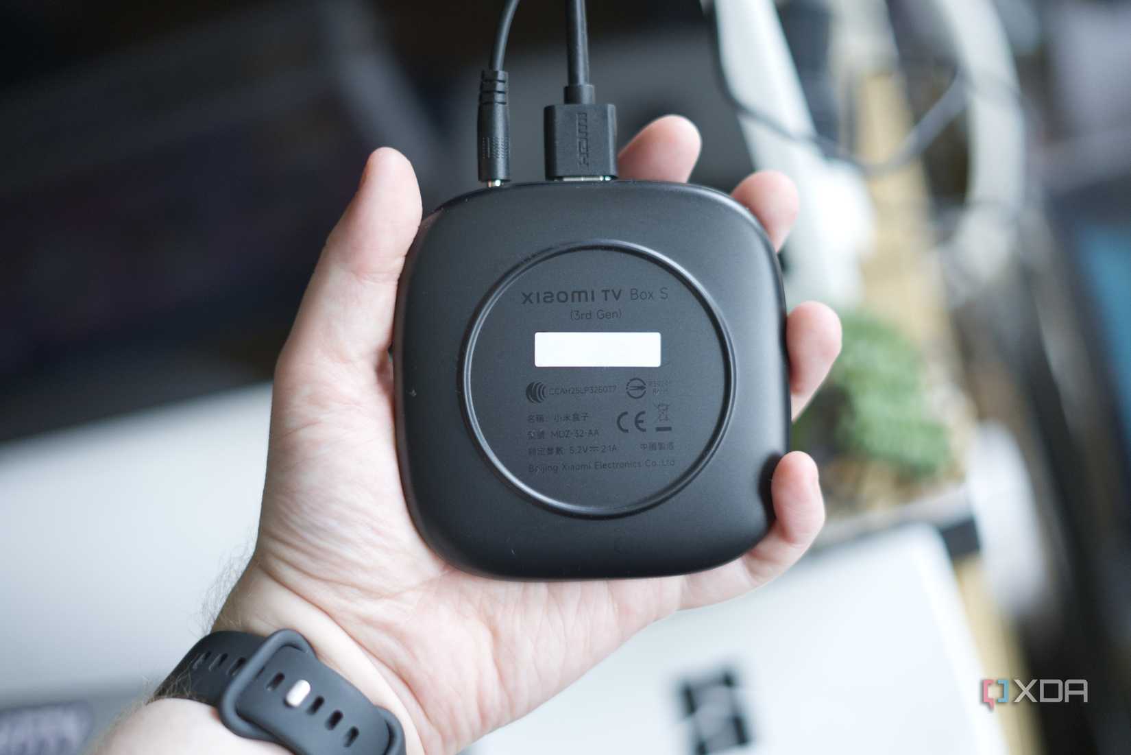 The underside of the Xiaomi TV Box S 3rd Gen, held in hand
