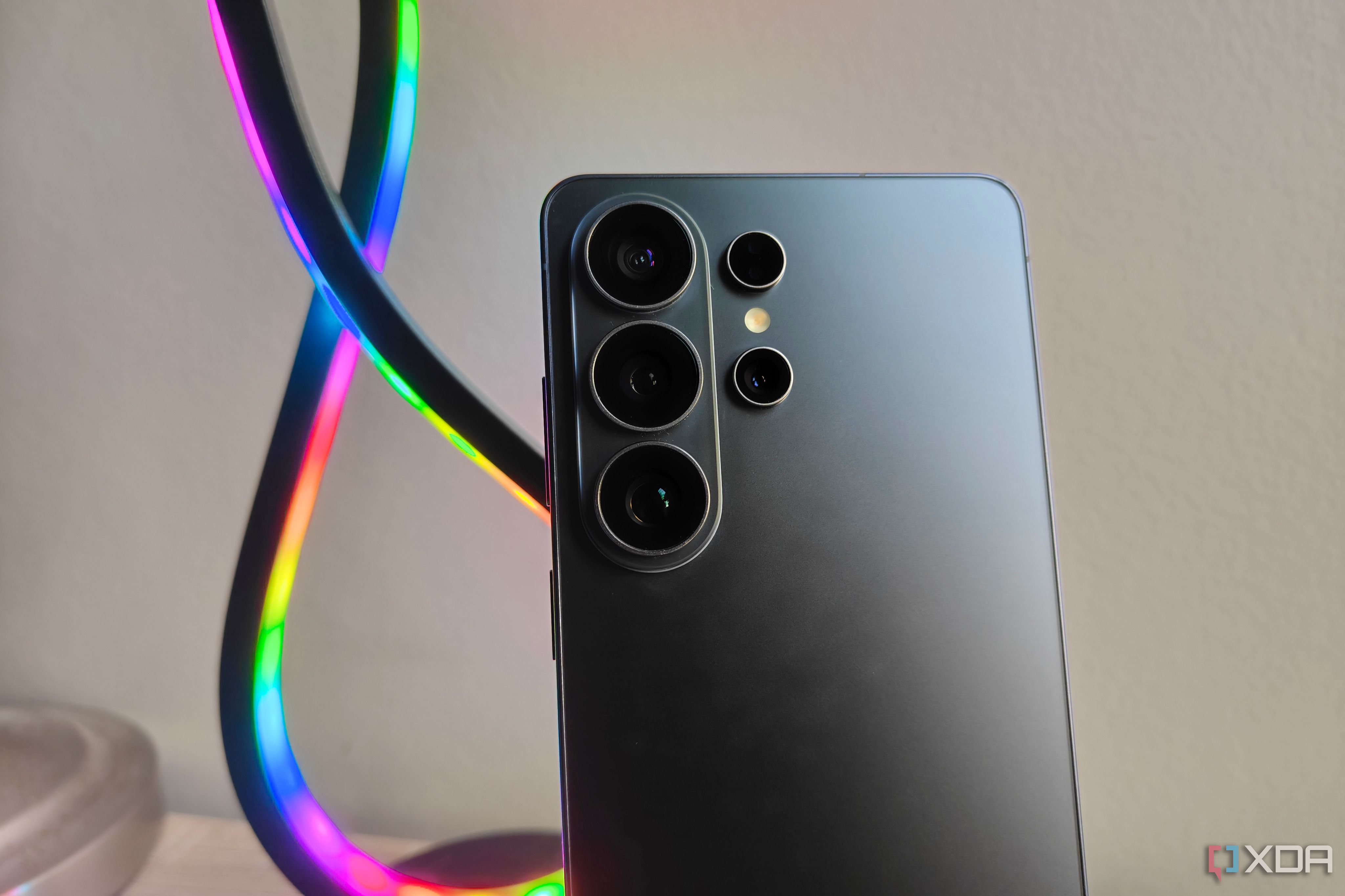 a samsung galaxy s26 ultra with a multicolored light in the background