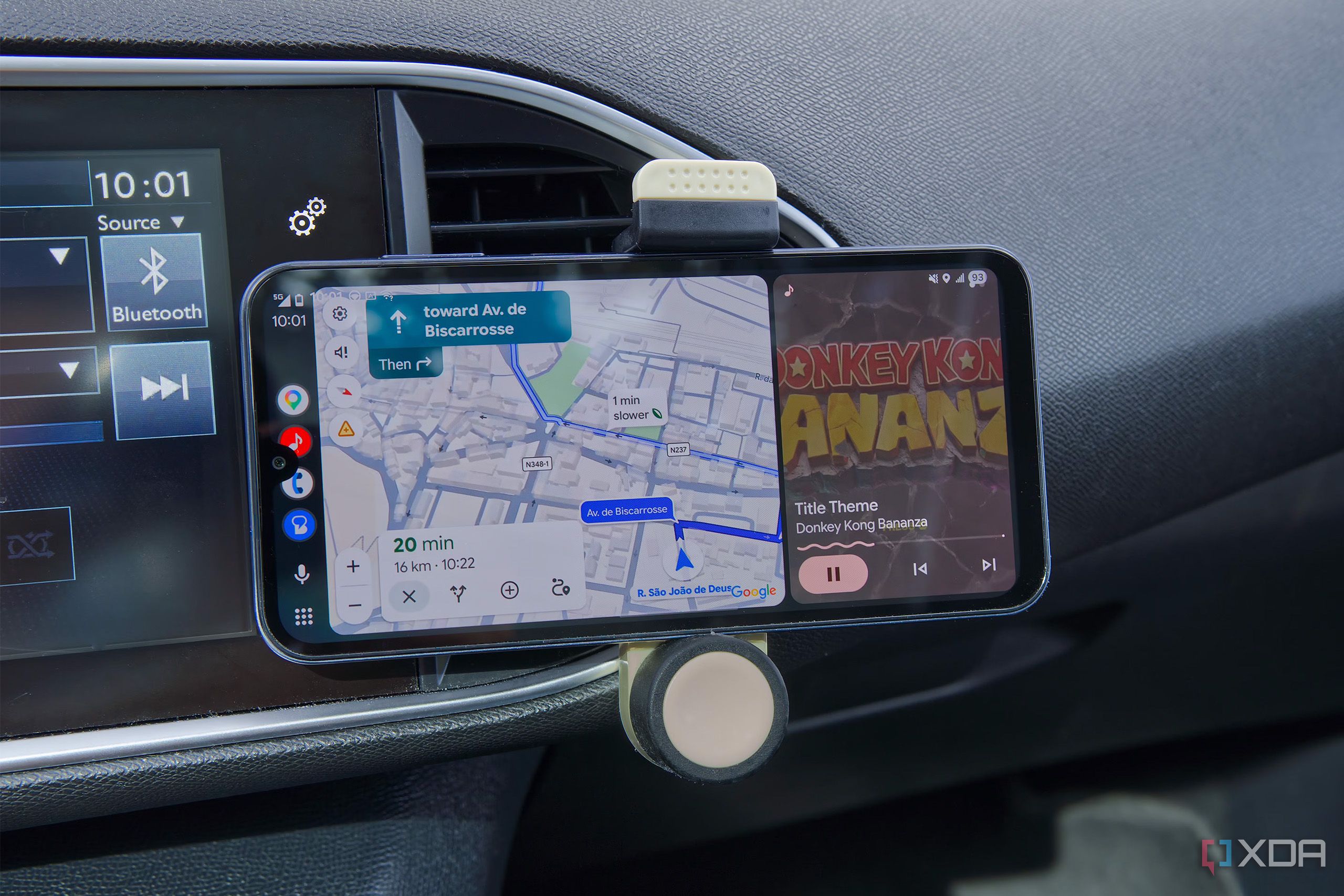 An Android phone displaying the Android Auto UI on a car's dashboard