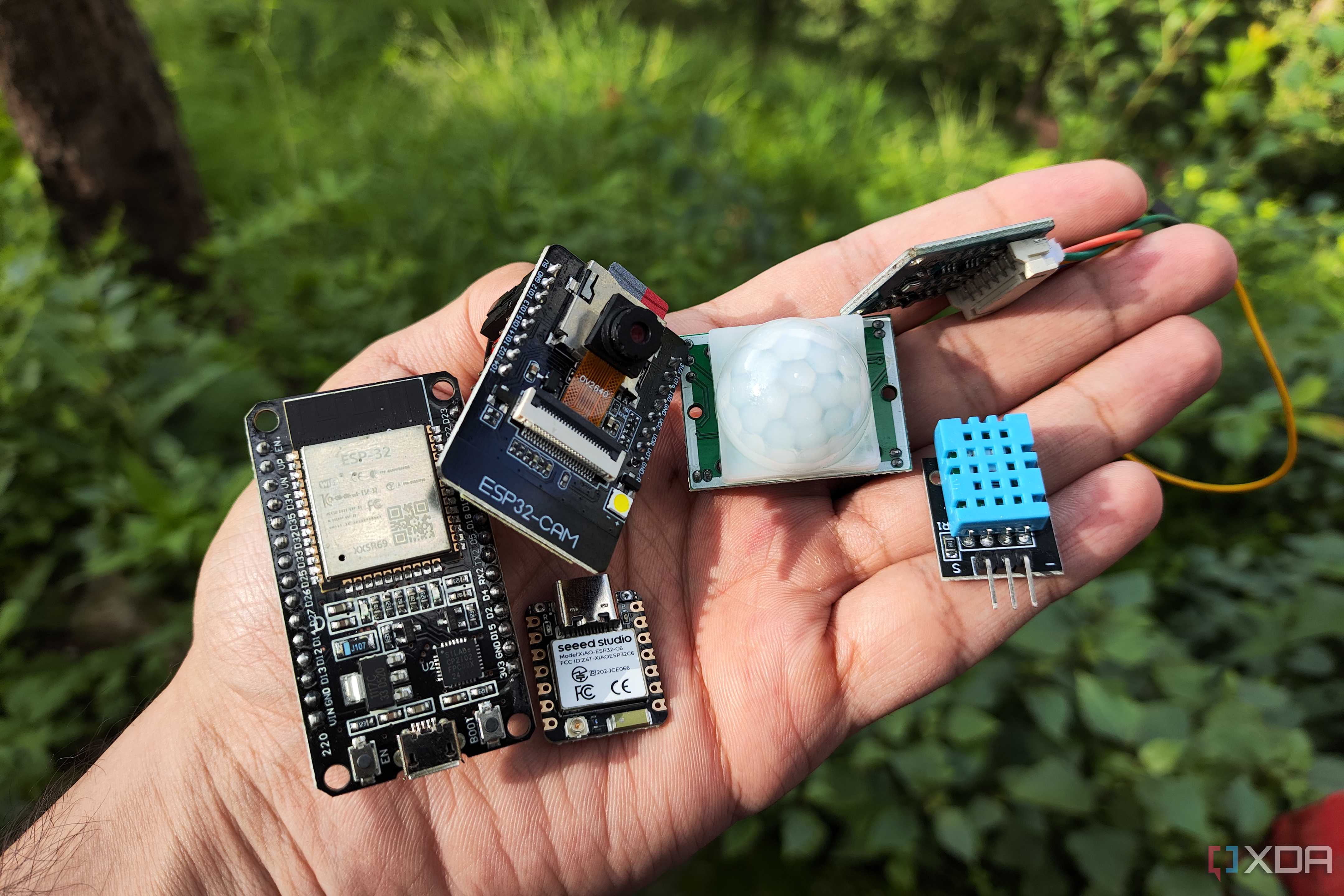A person holding multiple ESP32 systems