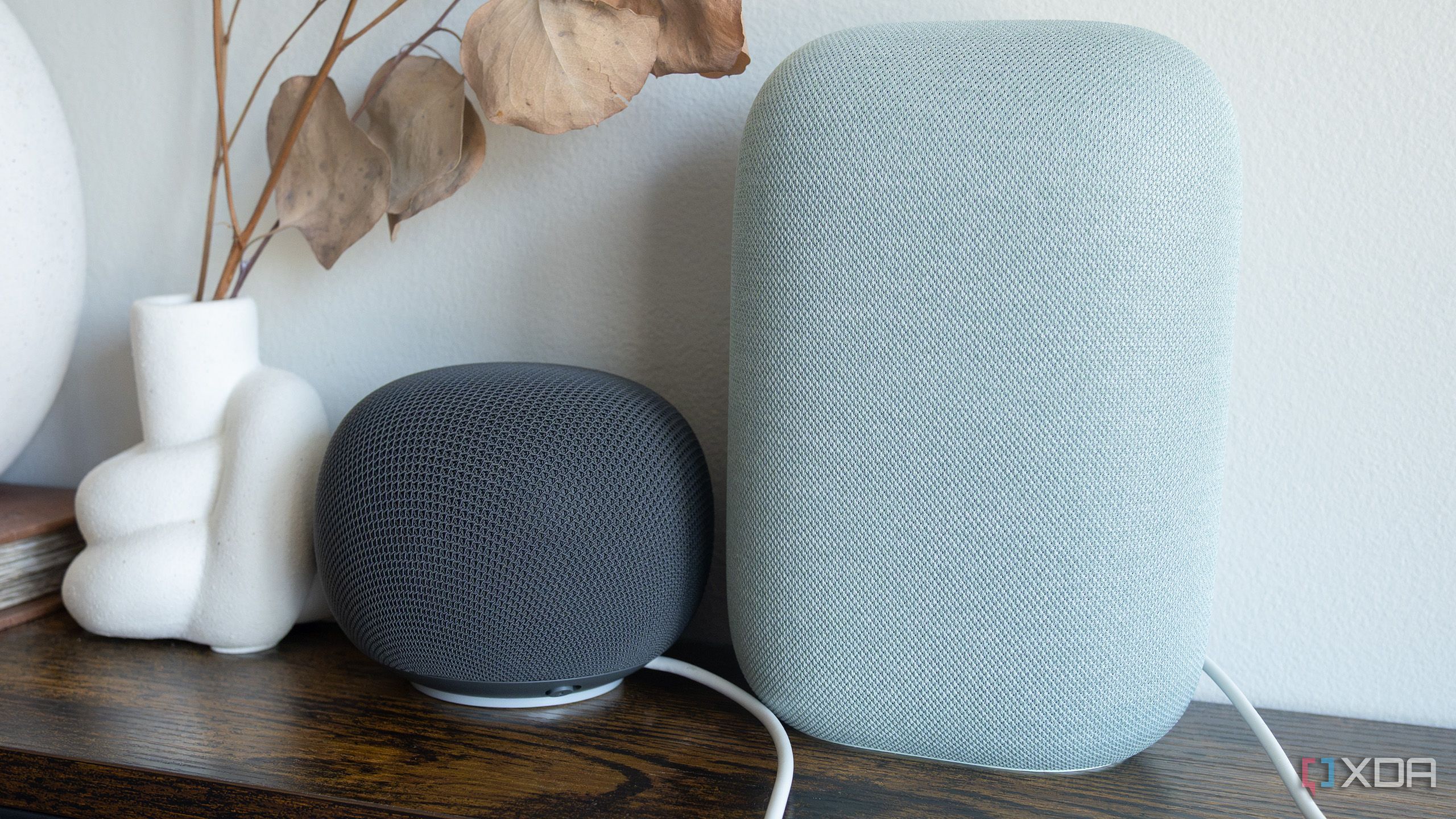 The Google Home Speaker sitting beside the Nest Audio 