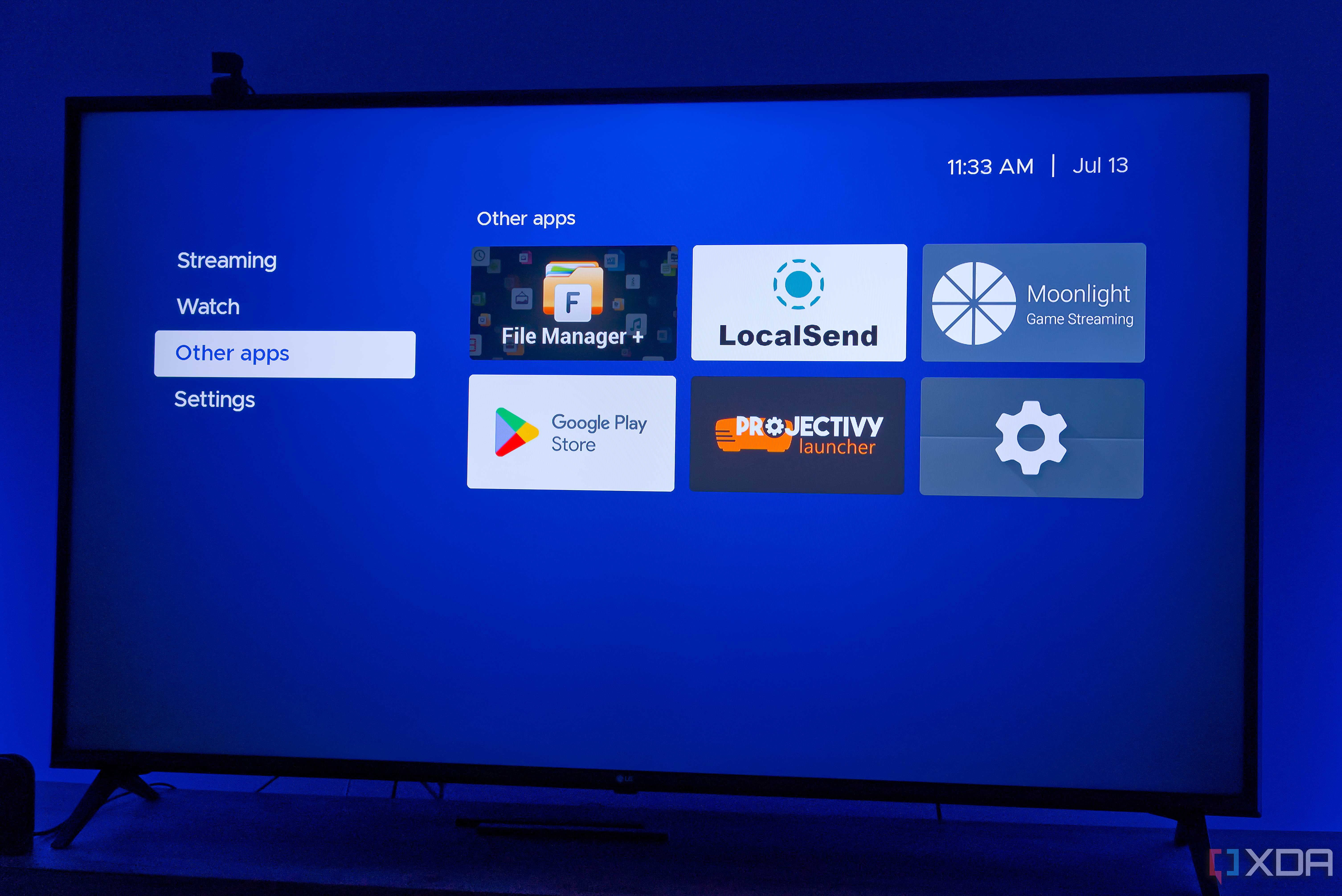 A TV displaying Kyu launcher for Android TV with a group of non-streaming apps