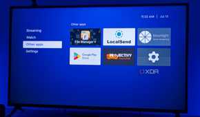 A TV displaying Kyu launcher for Android TV with a group of non-streaming apps