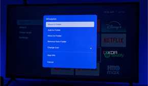 A TV displaying Kyuu Launcher for Android TV, with a menu of actions that can be taken on an app