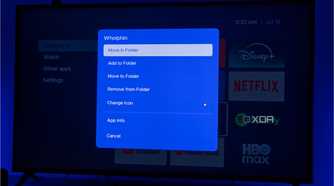 A TV displaying Kyuu Launcher for Android TV, with a menu of actions that can be taken on an app