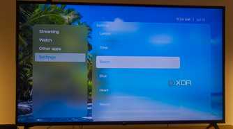 A TV displaying the Beach theme in Kyu launcher for Android TV