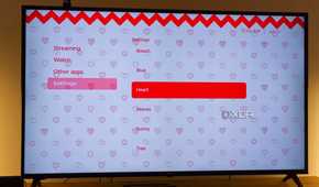 A TV displaying the Hearts theme in Kyu launcher for Android TV