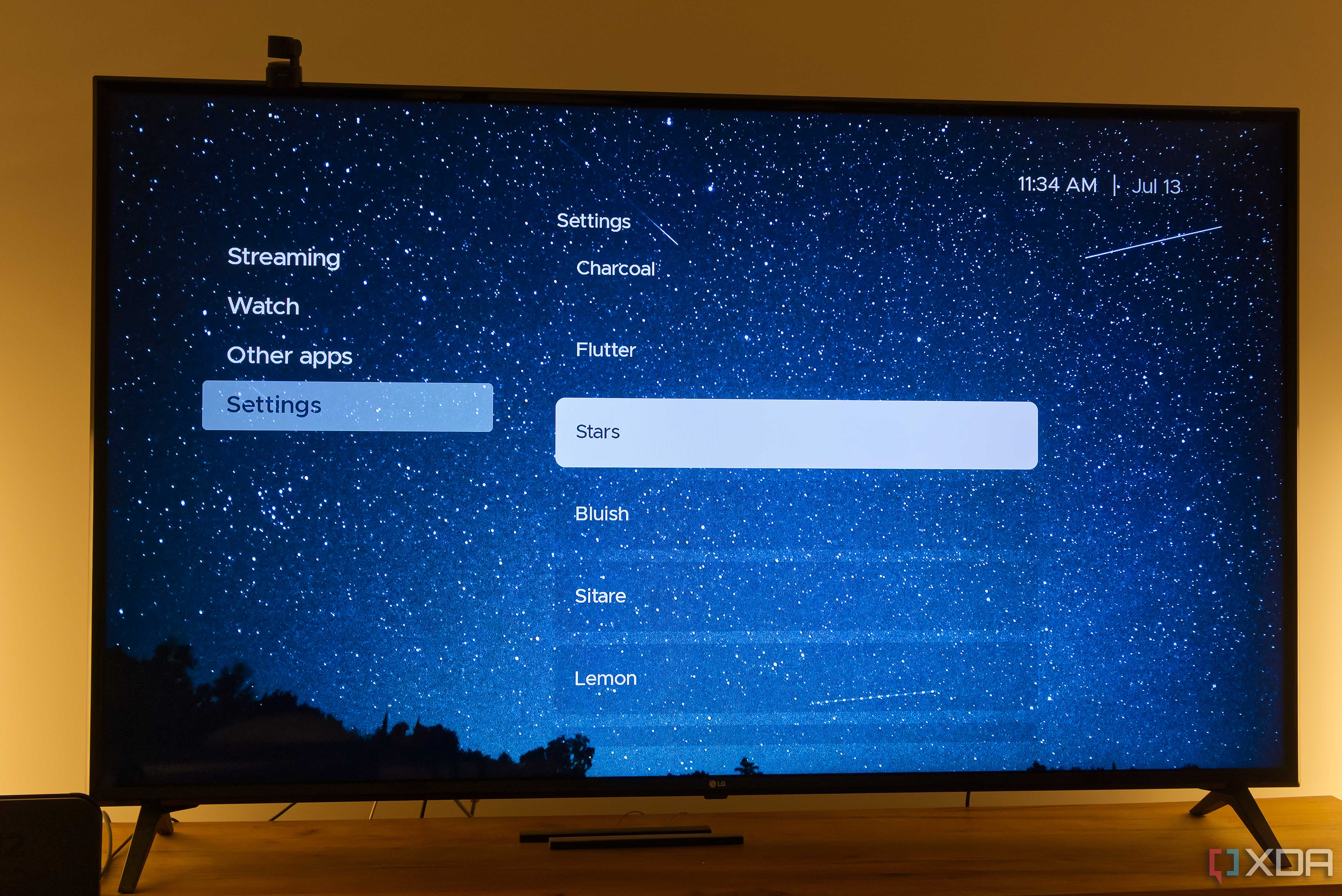 A TV displaying the Stars theme in Kyu launcher for Android TV