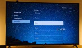 A TV displaying the Stars theme in Kyu launcher for Android TV