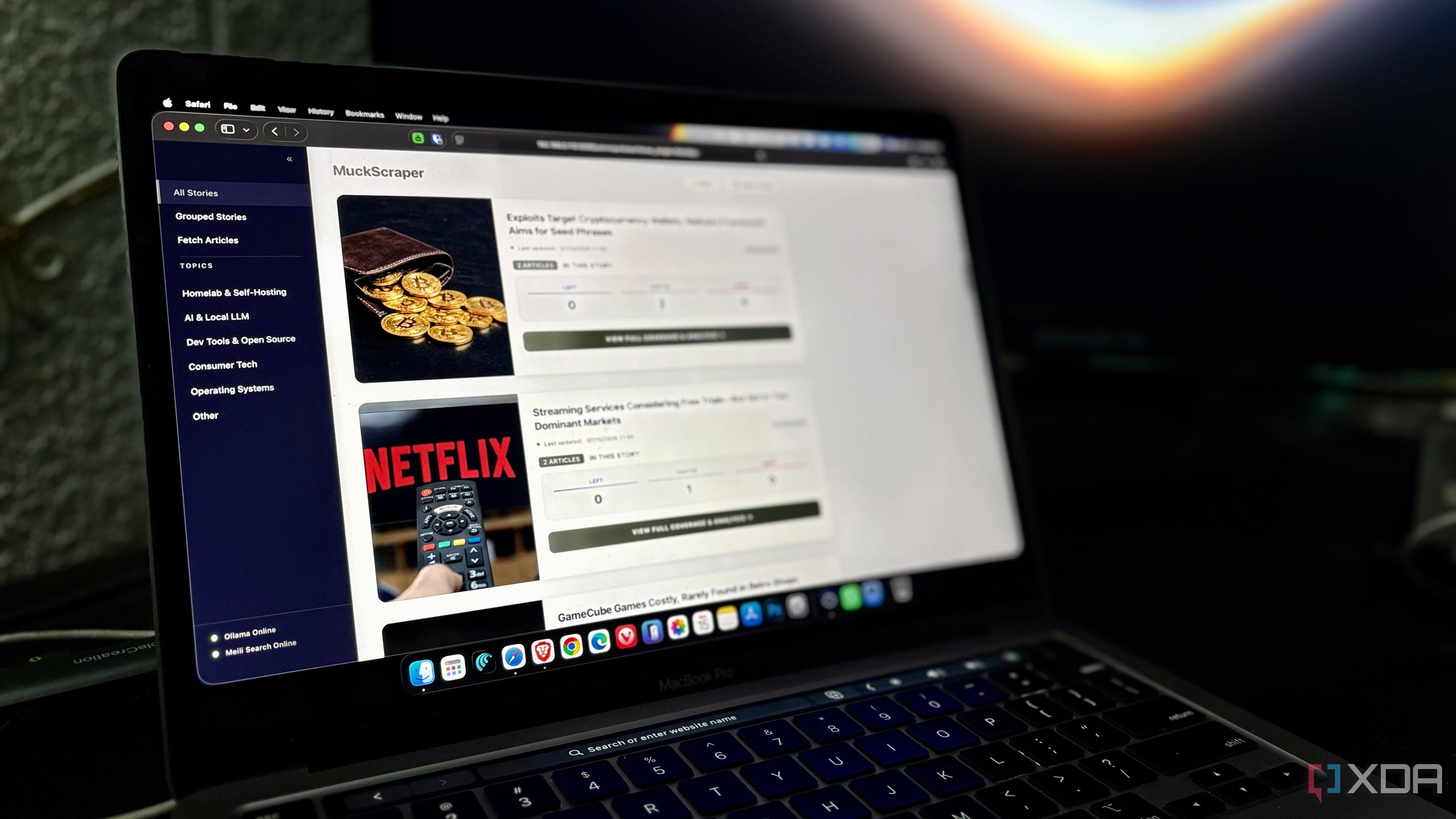 MacBook Pro screen showing the MuckScraper dashboard with homelab and tech news topics