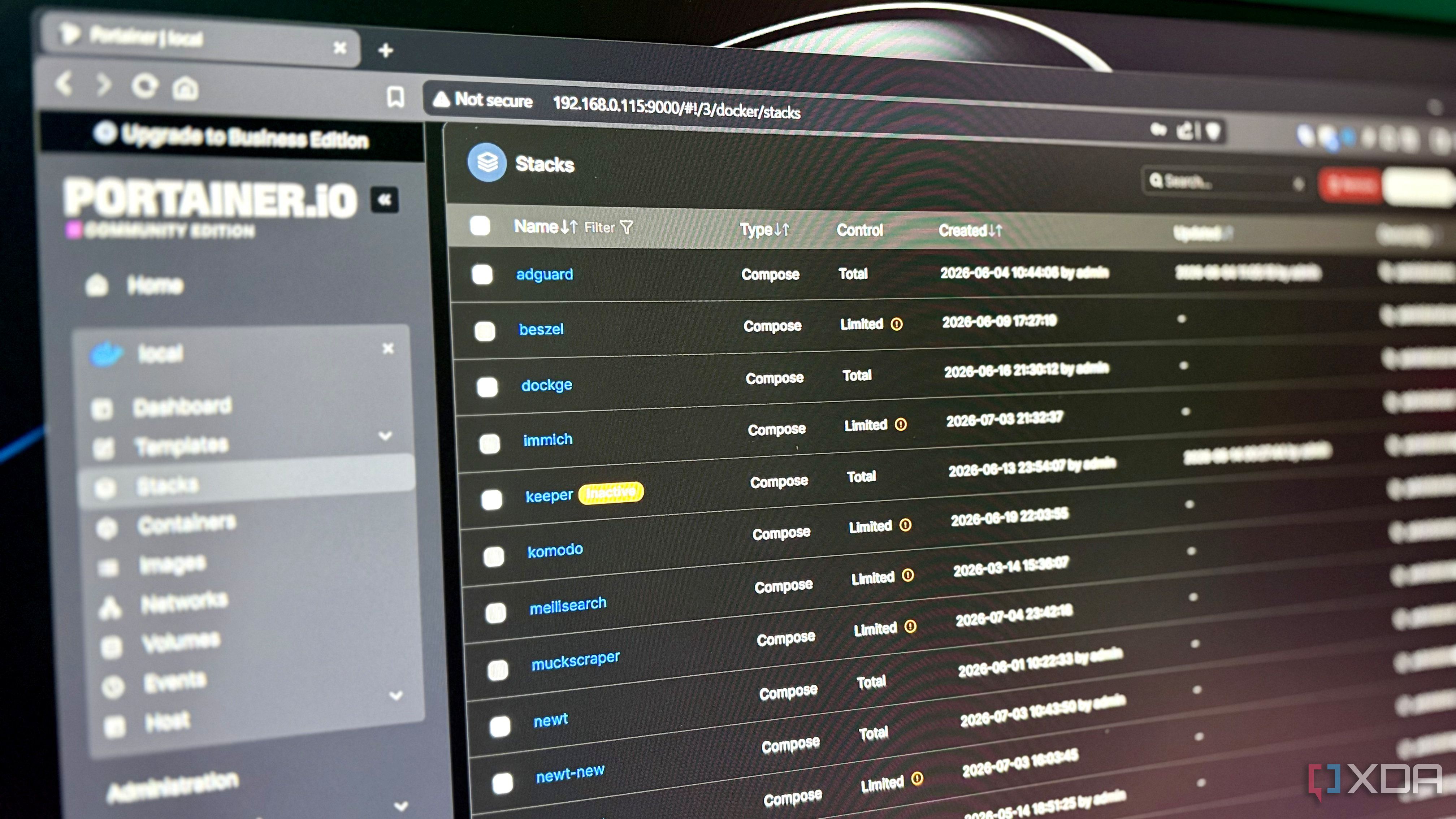 Portainer stacks dashboard displayed on a monitor, showing several stacks marked with a Limited control badge