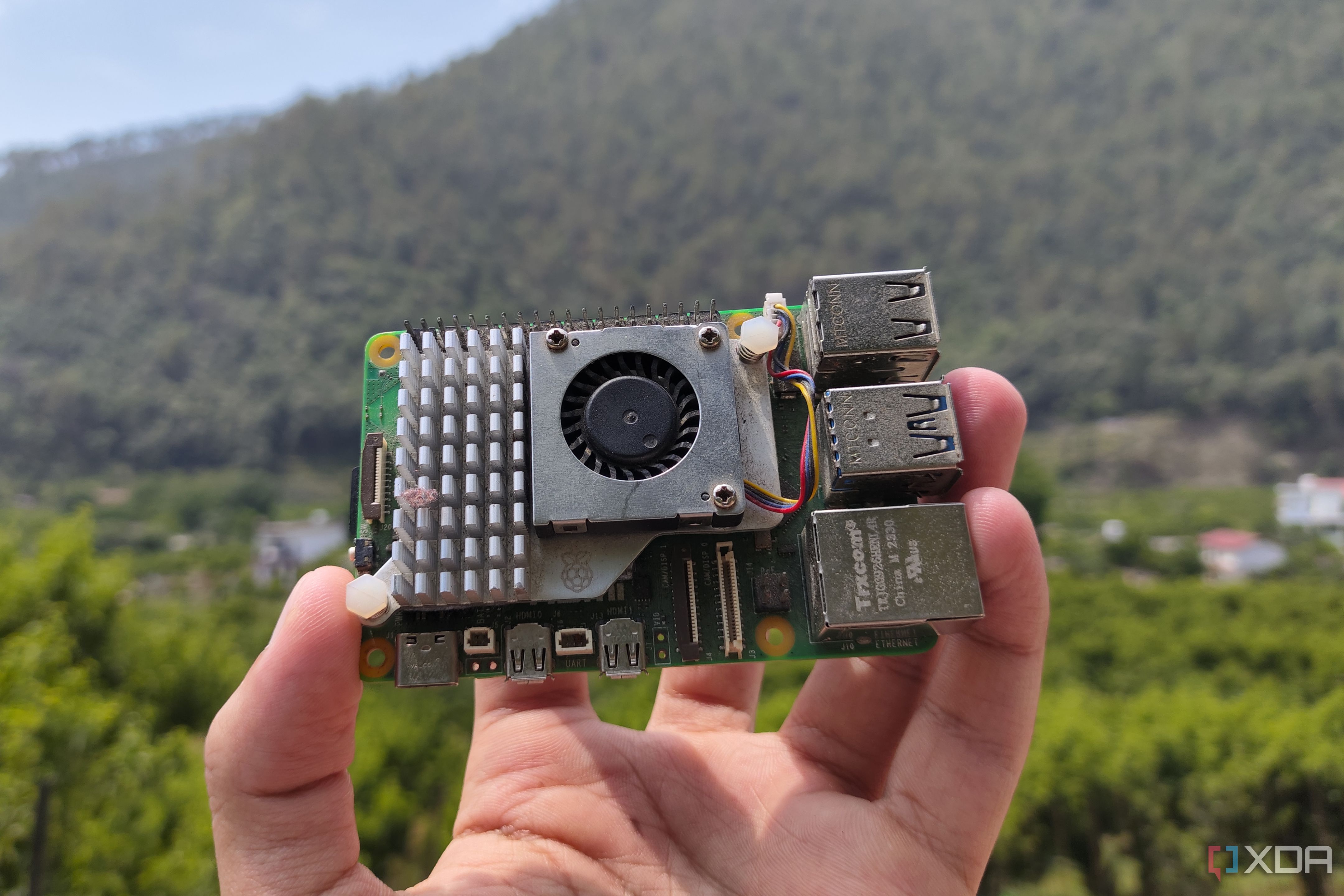 A person holding a Raspberry Pi 5