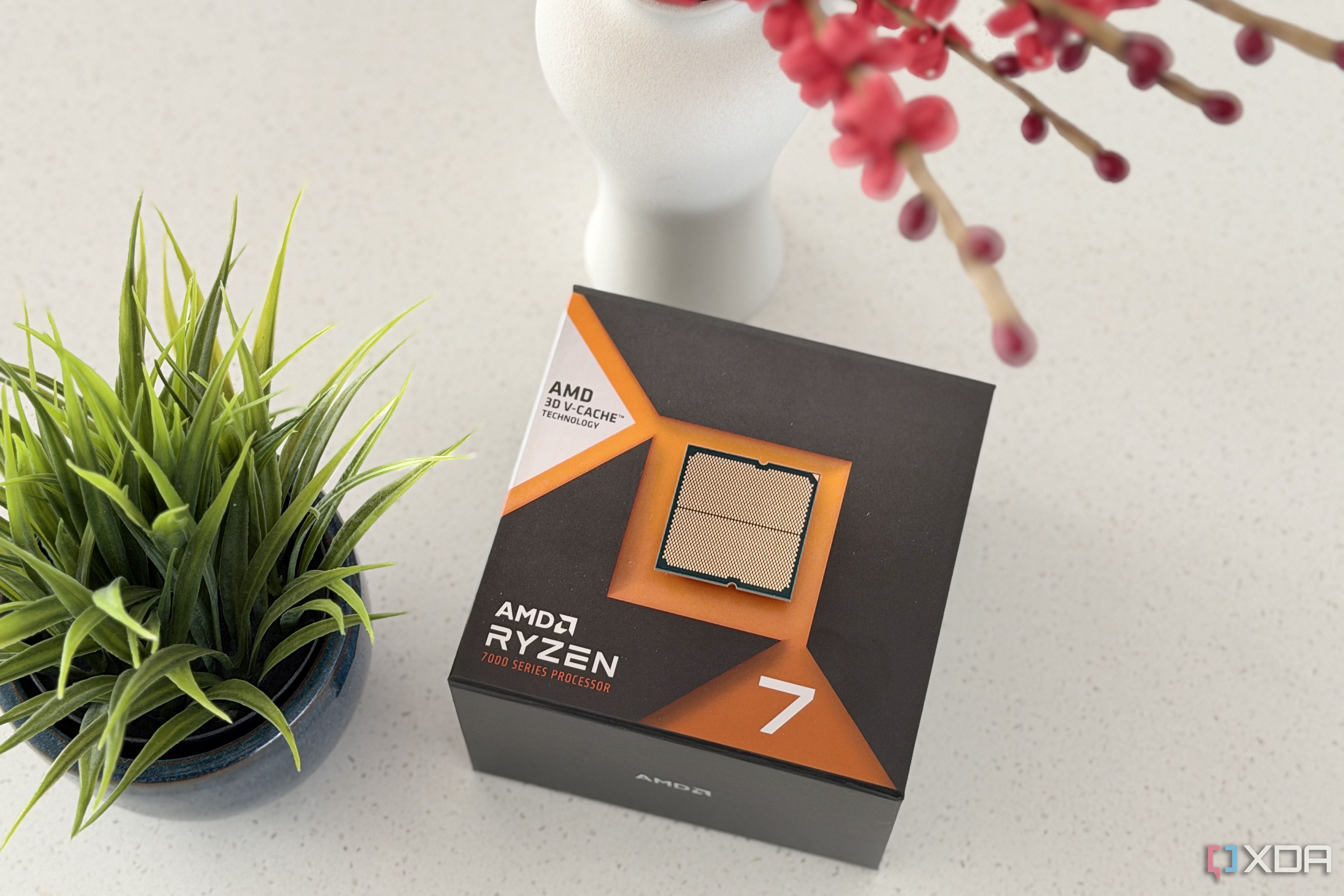 ryzen 7 7700x3d on top of box showing the pads side