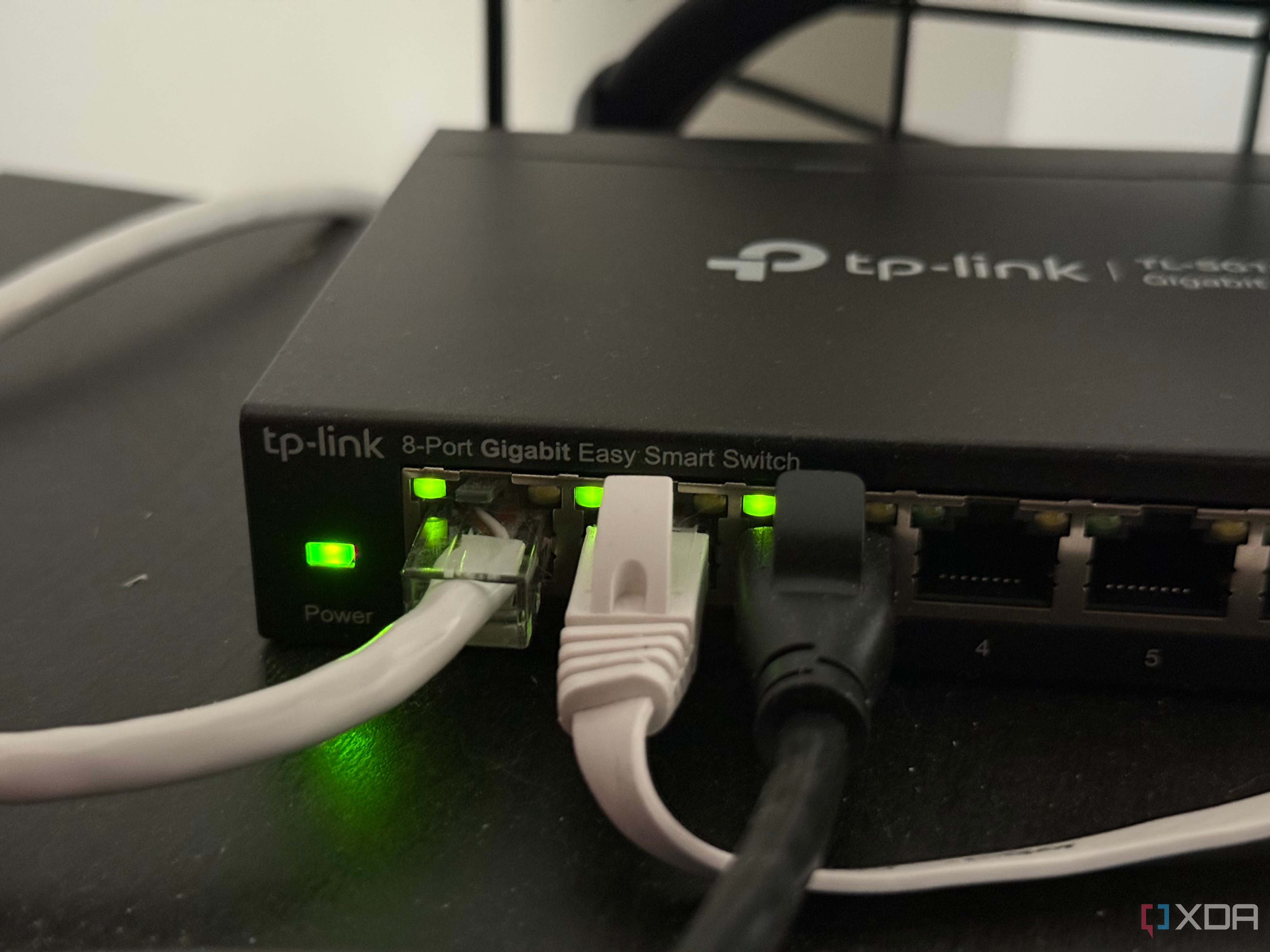 an 8 port ethernet switch with 3 ethernet cables plugged in