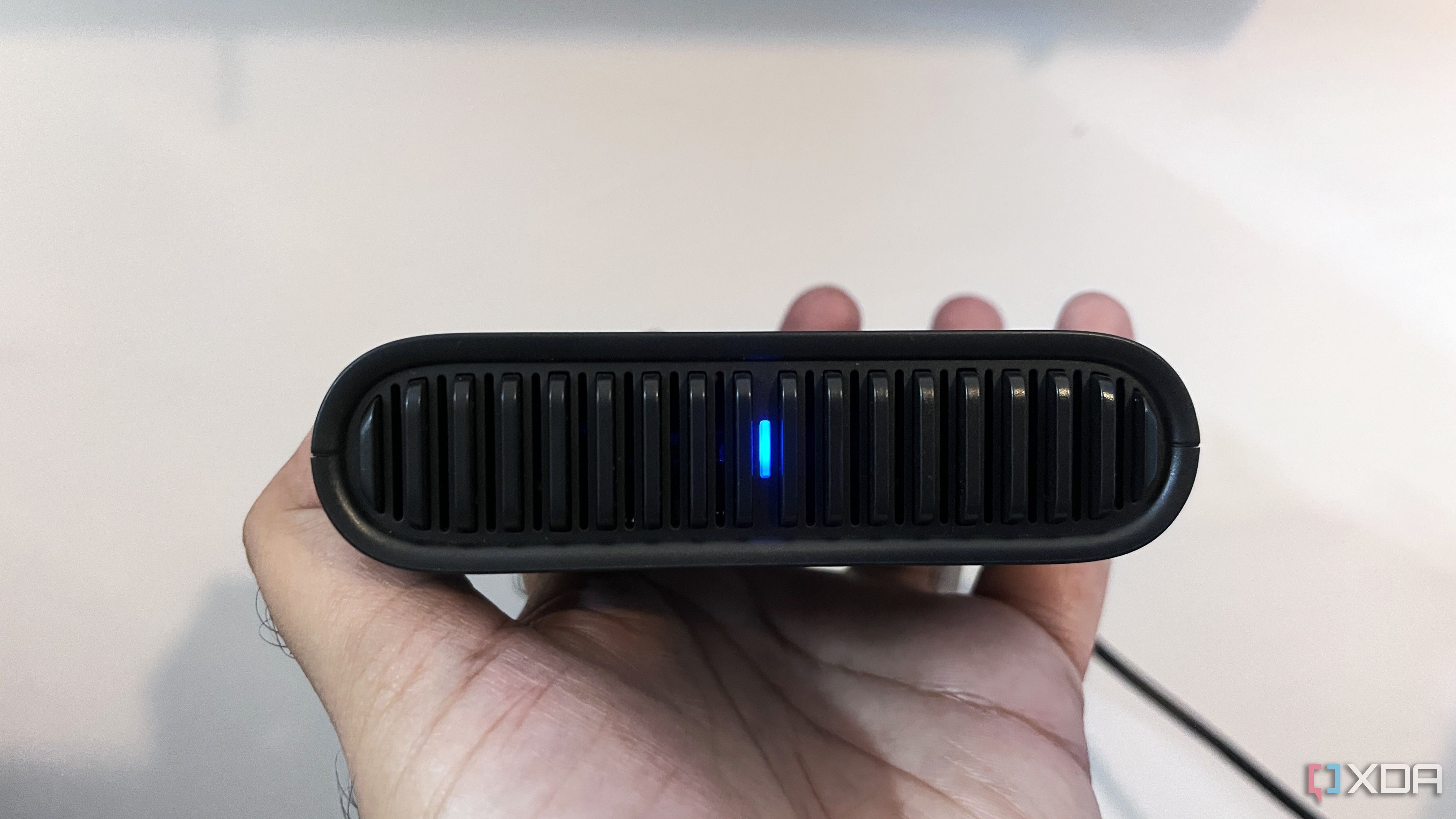 TP-Link travel router with blue light glowing