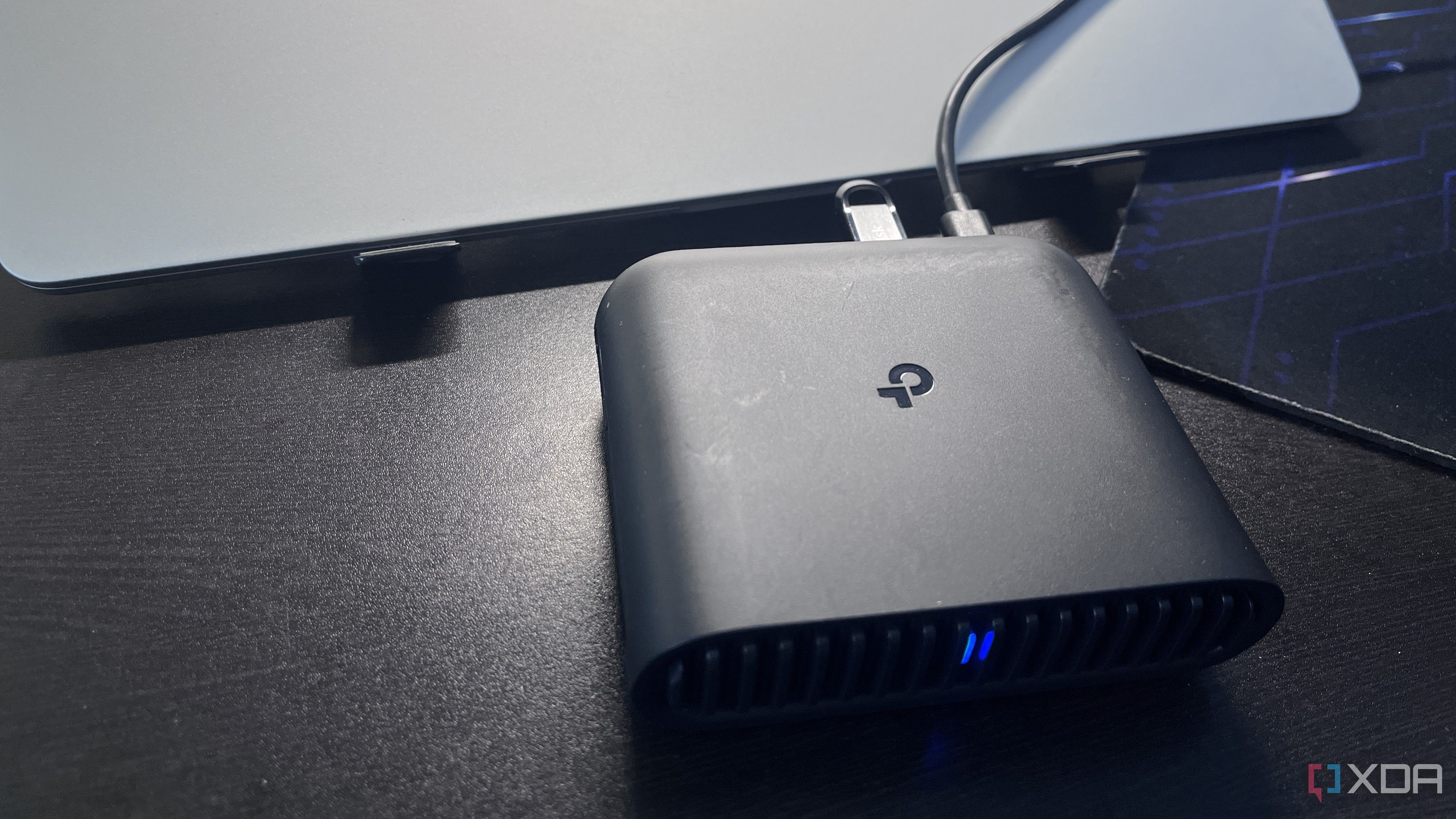 travel router with flash drive connected placed in front of a laptop 
