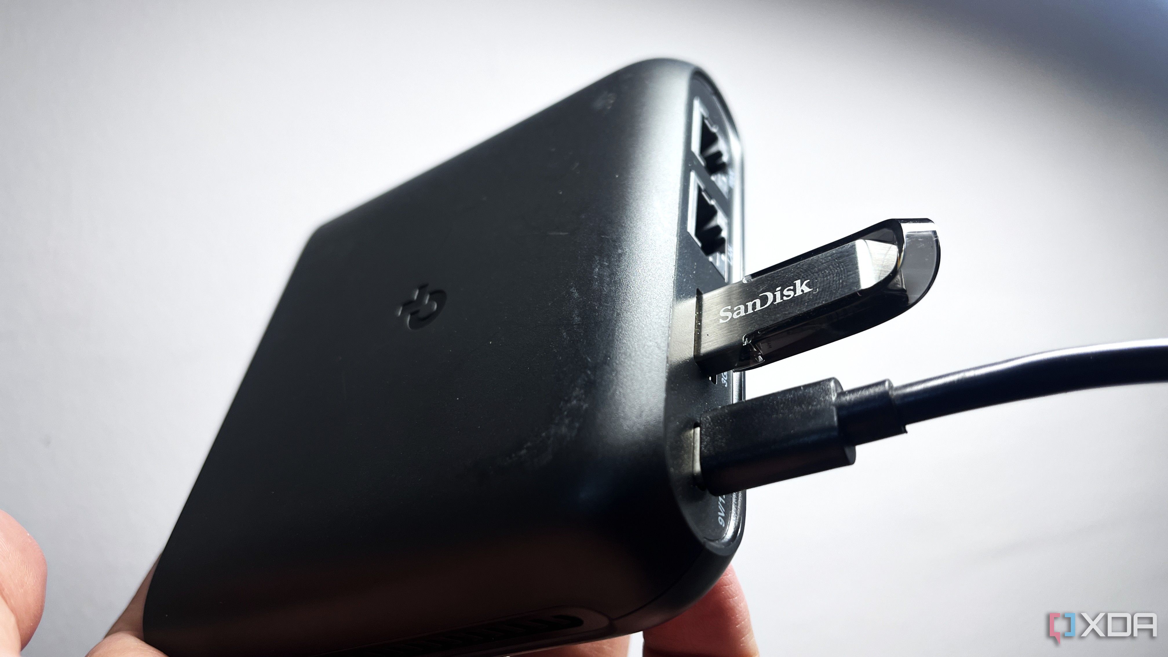 tp-link travel router with a sandisk flash drive connected to it