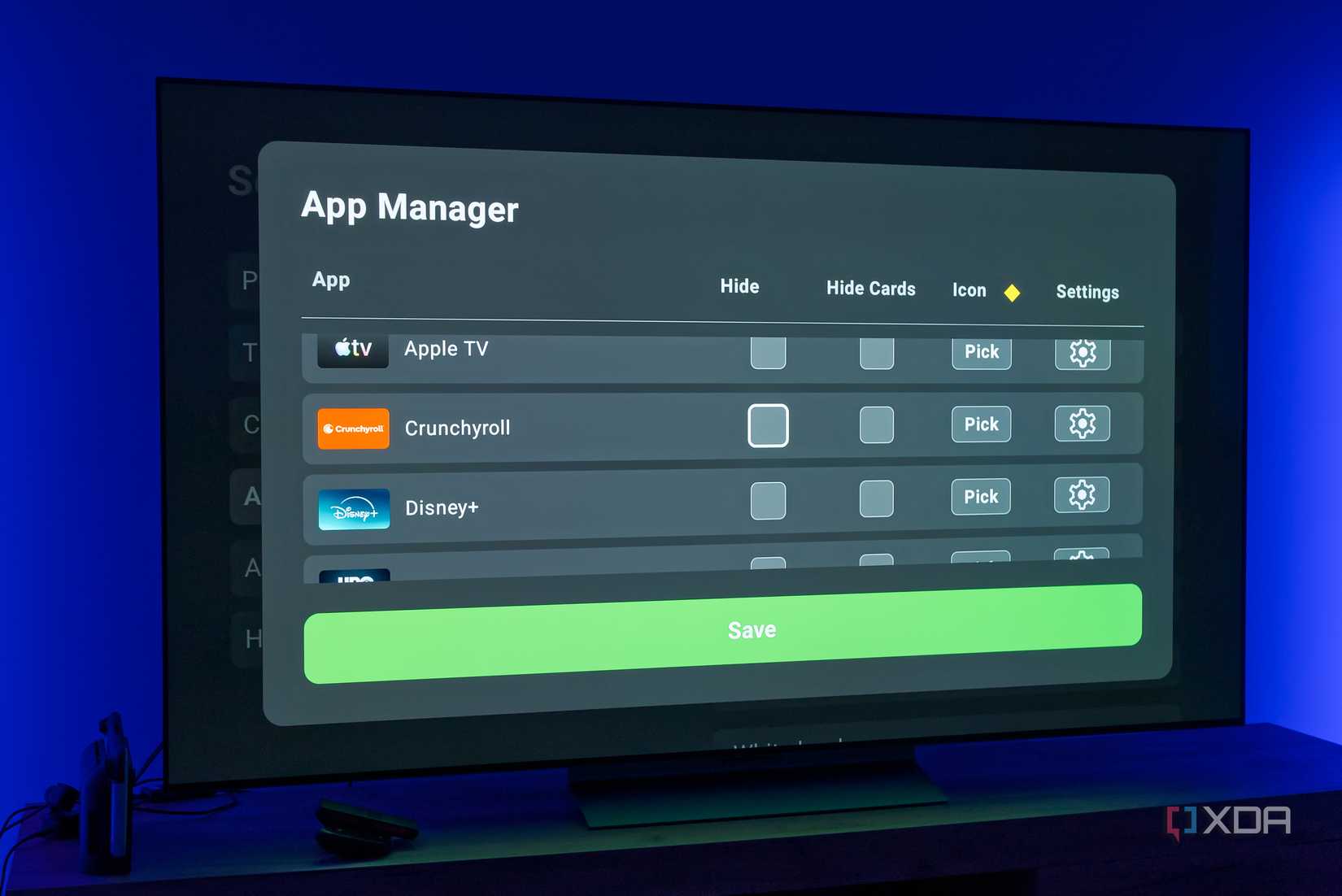 A TV displaying the app manager options for AT4K Launcher on Android TV, giving the user options to hide apps or their respective content cards
