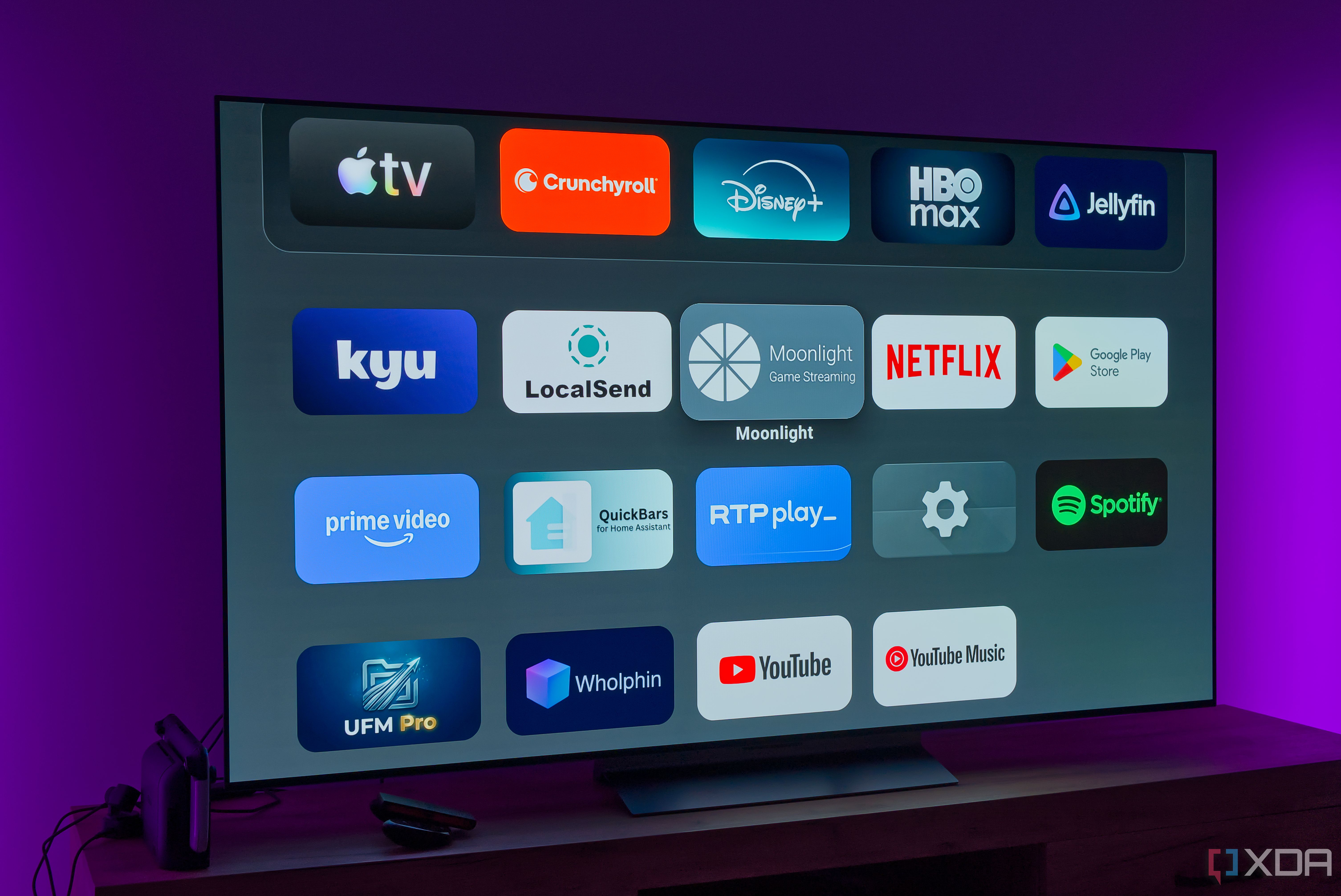 A TV showing the home page on the AT4K Launcher, showing a list of apps on a dark background