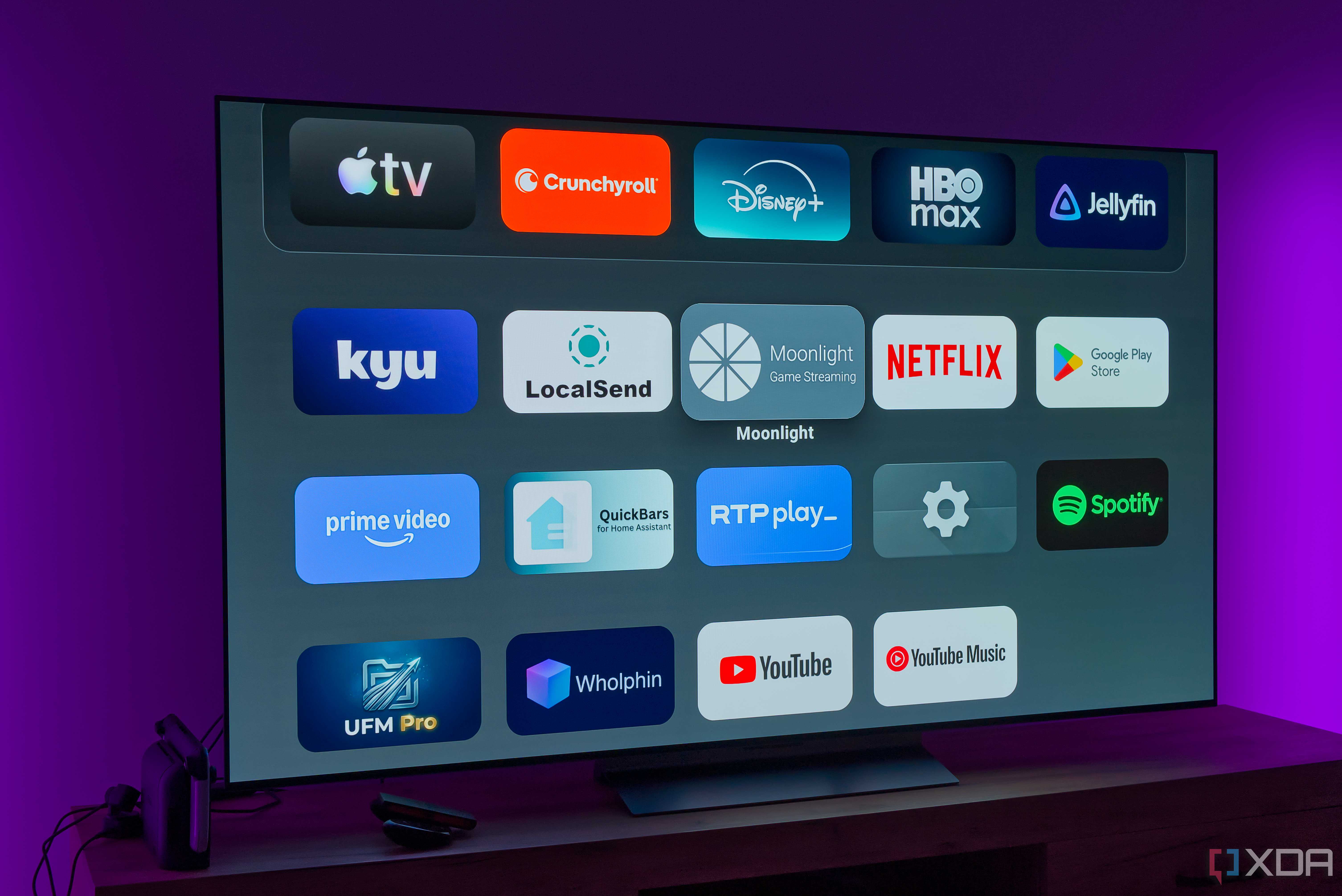 A TV showing the home page on the AT4K Launcher, showing a list of apps on a dark background