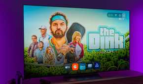 A TV displaying the homepage for AT4K Launcher on Android TV, with a full-screen wallpaper based on recommended content and a dock showing favorite apps in miniature size