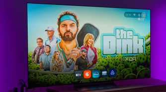 A TV displaying the homepage for AT4K Launcher on Android TV, with a full-screen wallpaper based on recommended content and a dock showing favorite apps in miniature size