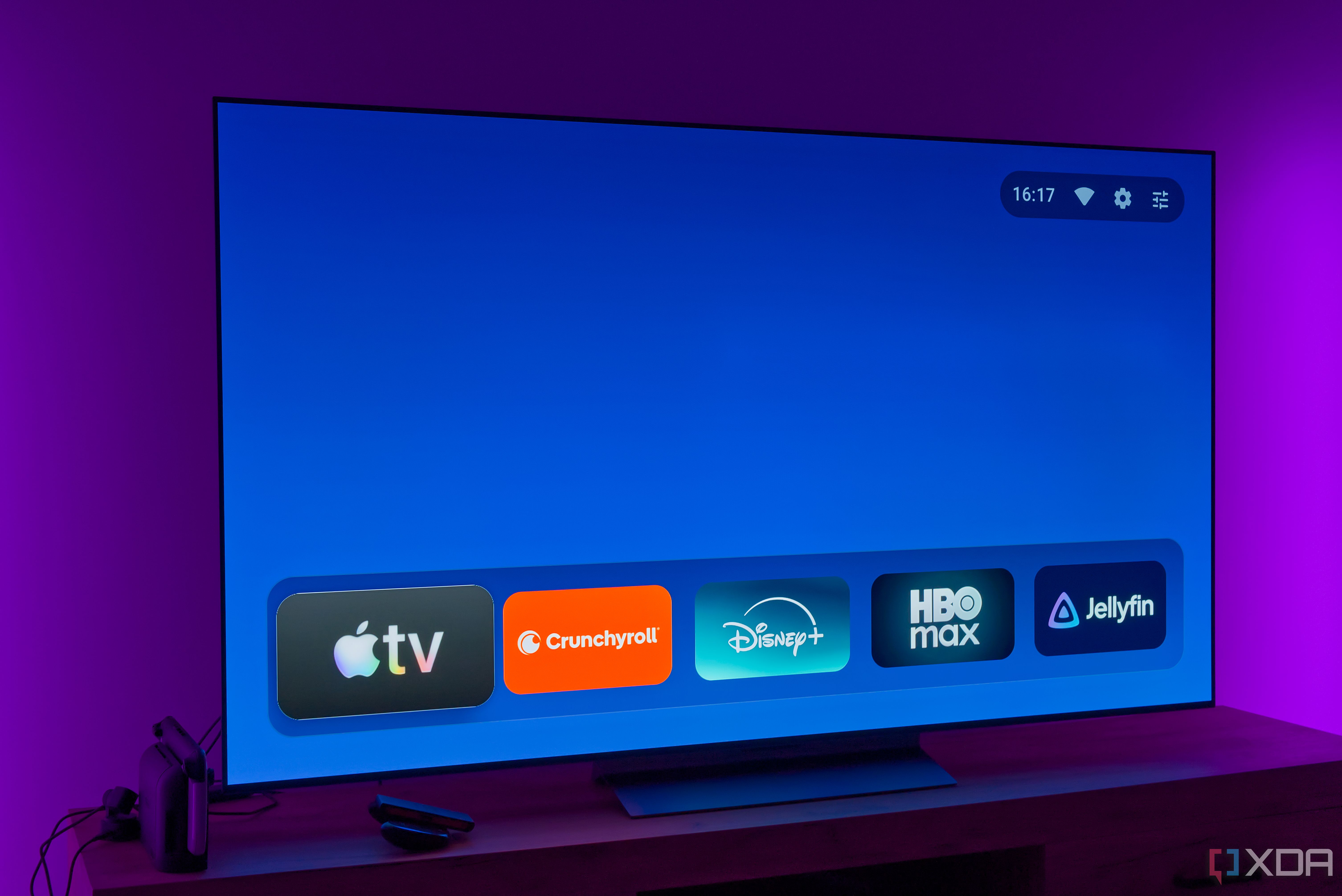 A TV displaying the AT4K Launcher homepage without featured cards and with a favorite app list in its normal size