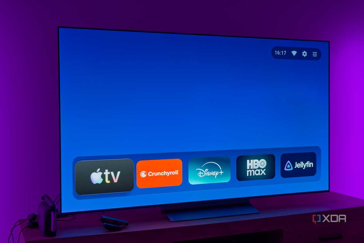 A TV displaying the AT4K Launcher homepage without featured cards and with a favorite app list in its normal size