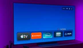 A TV displaying the AT4K Launcher homepage without featured cards and with a favorite app list in its normal size