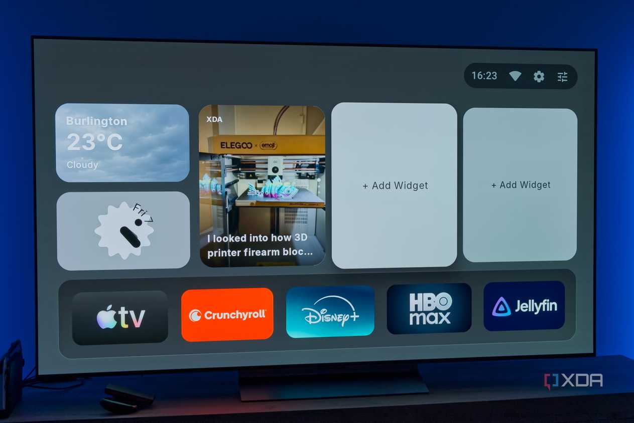 A TV displaying the homepage for AT4K Launcher for Android TV, with a small weather widget, a small analog clock widget, and one full-size RSS feed widget for XDA. Two widget slots are left open