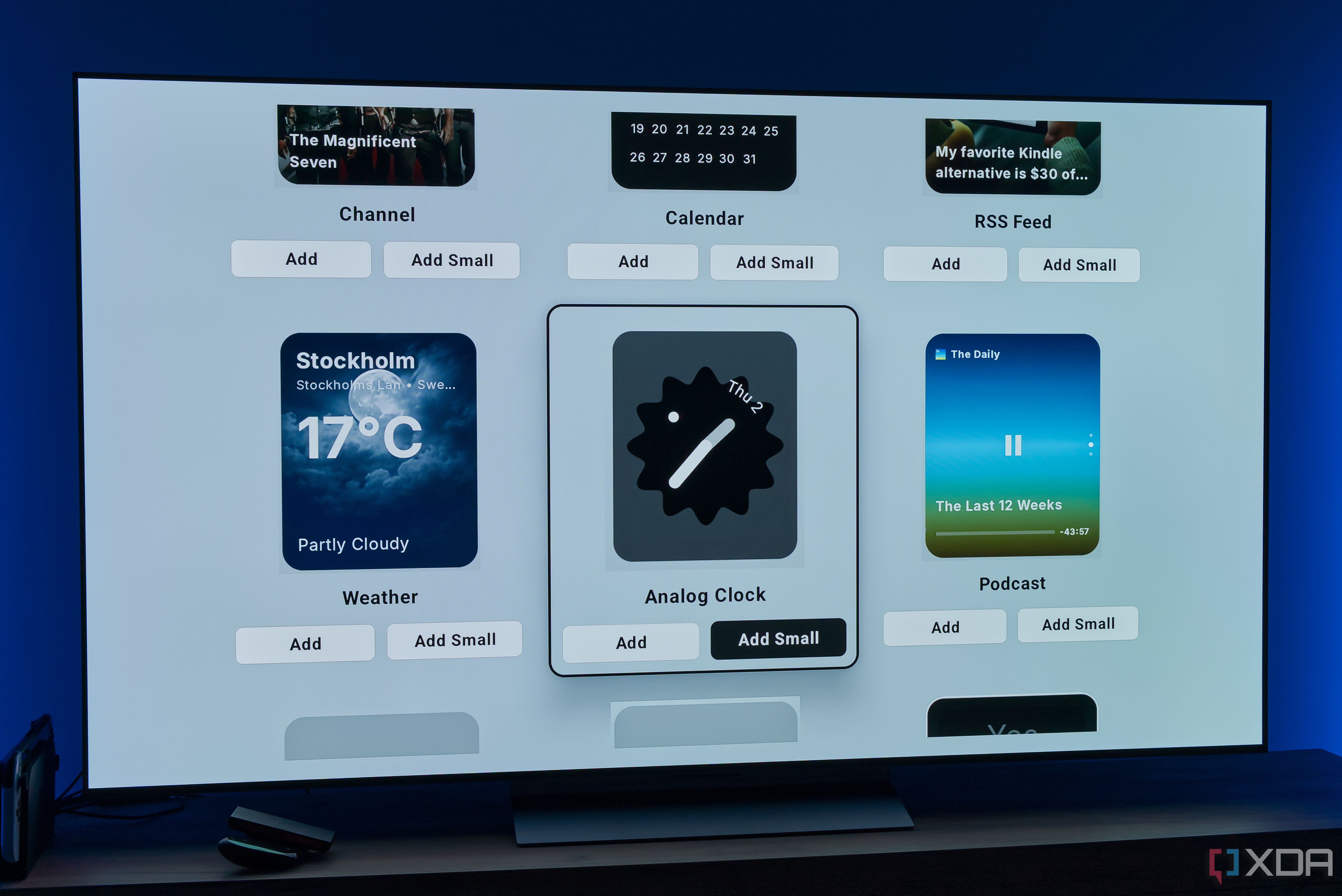 A TV showing more widgets that can be added to the AT4K Launcher homepage, including weather, an analog clock, and a podcast