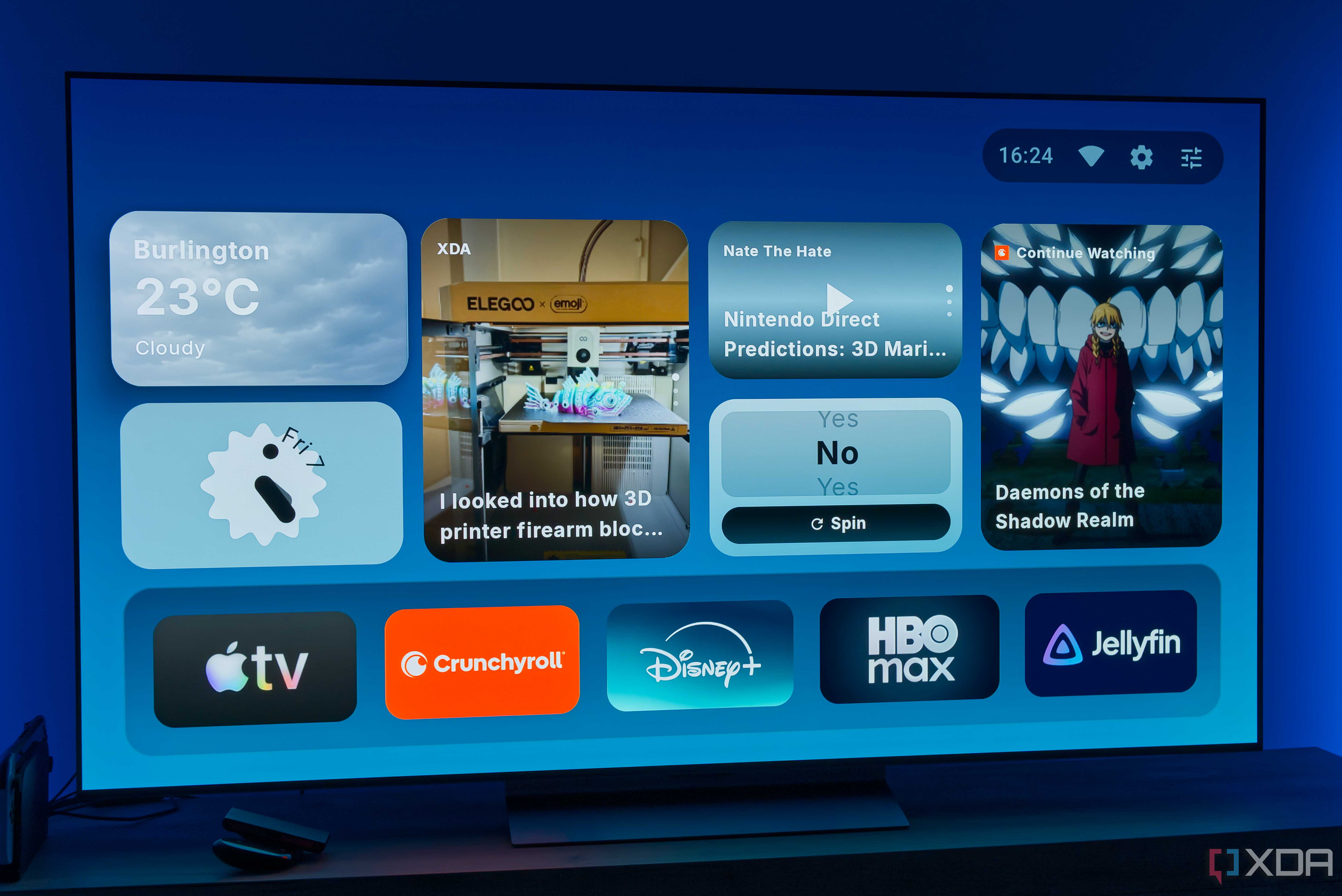 A TV displaying the homepage for AT4K Launcher for Android TV, with a small weather widget, a small analog clock widget, one full-size RSS feed widget for XDA, a small podcast widget, a small "Yes or no" spinner, and a "continue watching" card