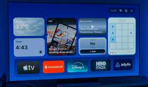 A TV displaying the homepage for AT4K Launcher for Android TV, with a small weather widget, a small timer widget, one full-size RSS feed widget for XDA, a small podcast widget, a small "Yes or no" spinner, and a 2048 game widget